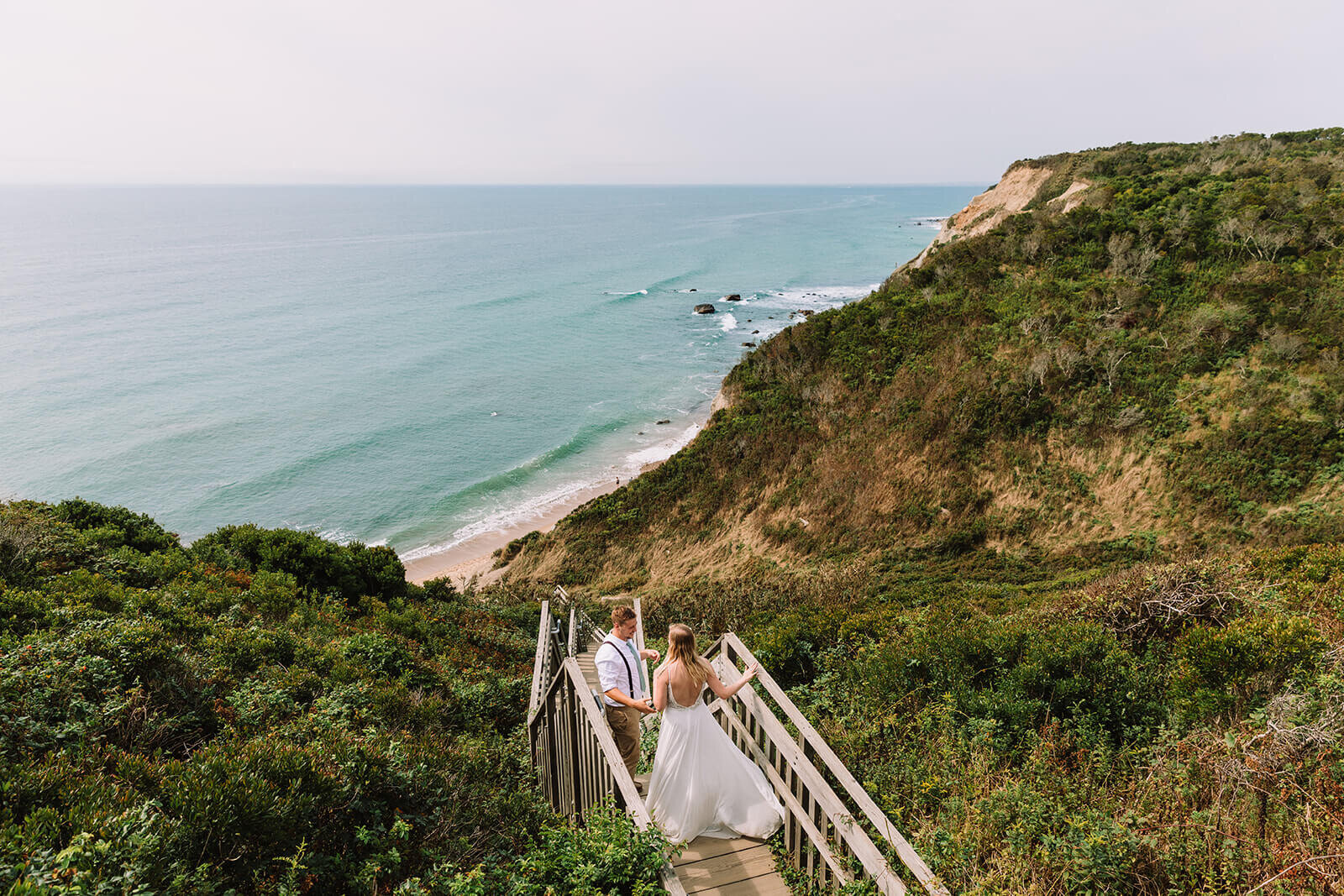  Couple explores Mohegan Bluffs during their hiking and beach elopement on Block Island off the coast of Rhode Island. 