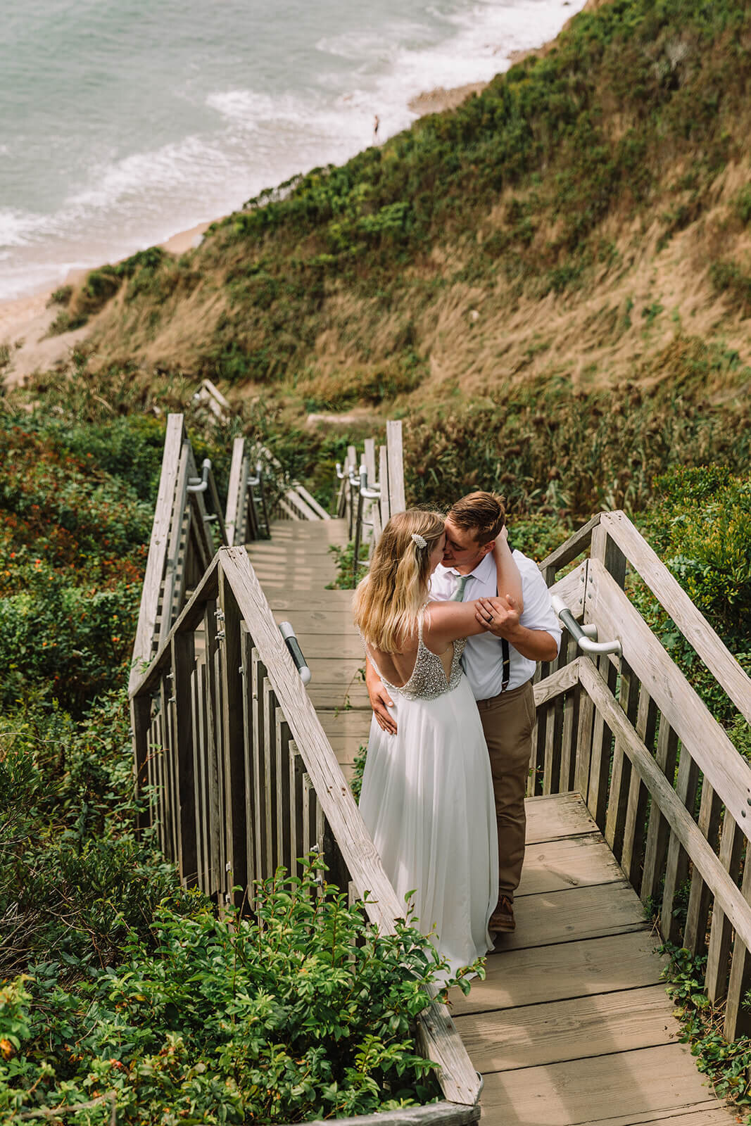 Couple explores Mohegan Bluffs during their hiking and beach elopement on Block Island off the coast of Rhode Island. 