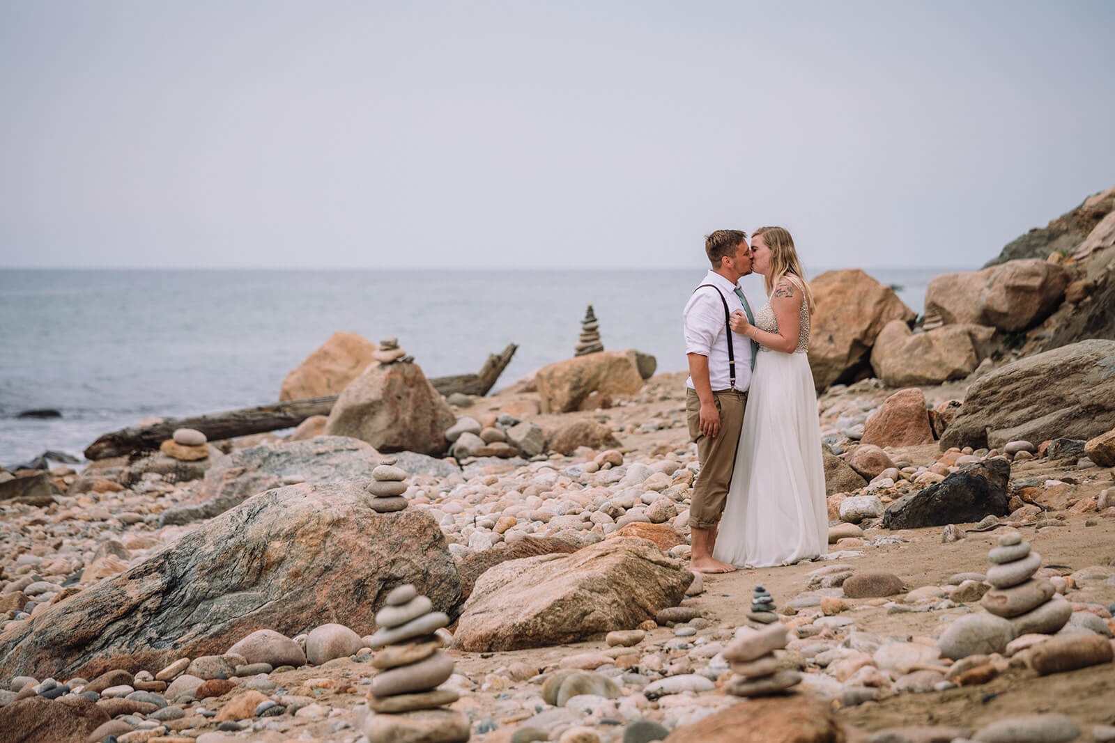  Couple explores Mohegan Bluffs during their hiking and beach elopement on Block Island off the coast of Rhode Island. 