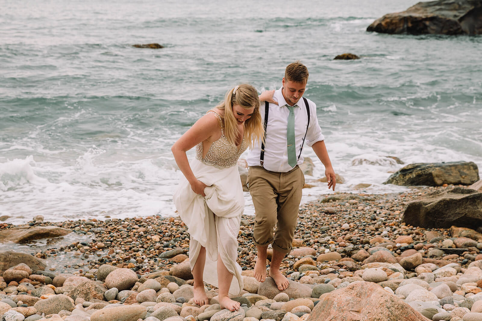  Couple explores Mohegan Bluffs during their hiking and beach elopement on Block Island off the coast of Rhode Island. 