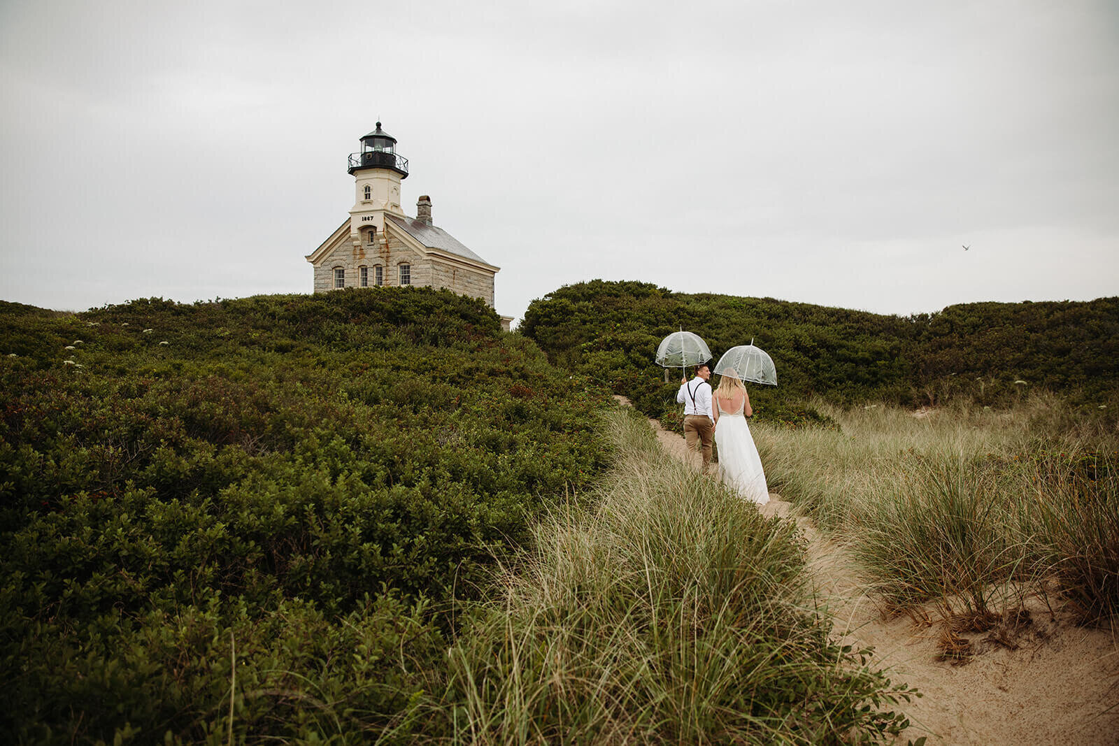  Eloping couple explores a lighthouse during their hiking and beach elopement on Block Island off the coast of Rhode Island. 