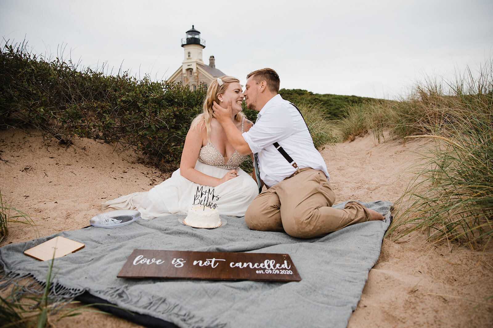 Eloping couple explores a lighthouse in the rain during their hiking and beach elopement on Block Island off the coast of Rhode Island. 
