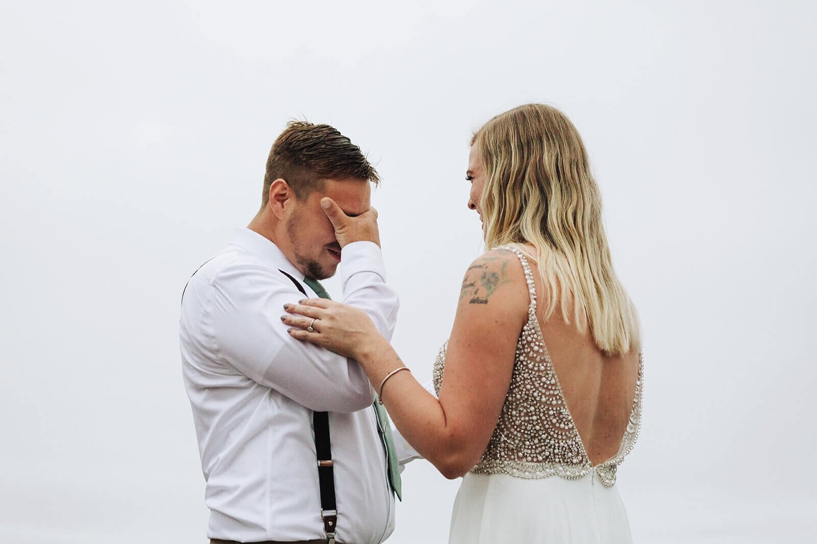  Groom tears up during the first look as part of their elopement on the Rhode Island Coast in Narragansett. 