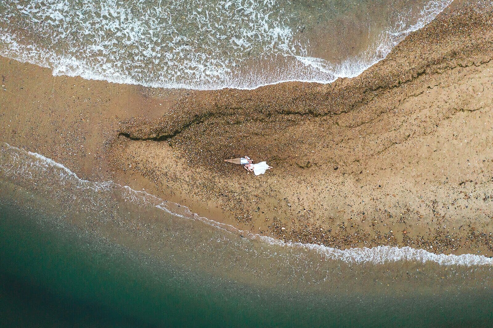  Eloping couple explores coastal views and sees a seal pop up during their hiking and beach elopement on Block Island off the coast of Rhode Island. 