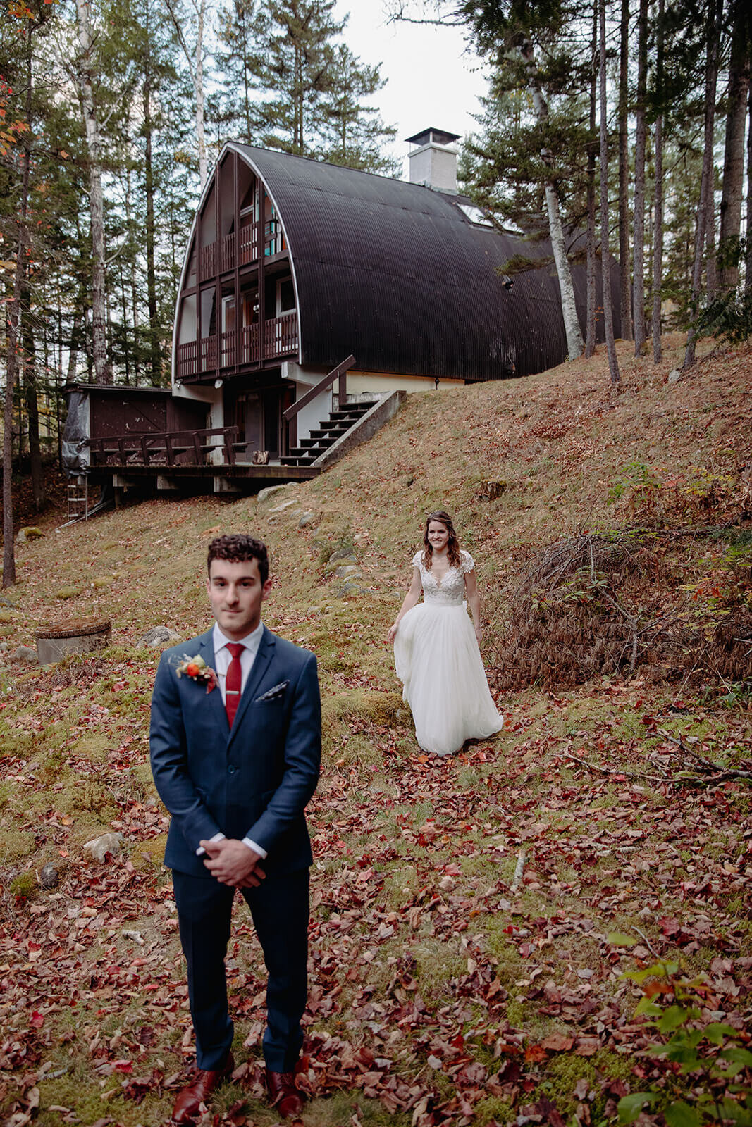  Groom waits for his bride during the first look during their colorful fall New Hampshire elopement. Small outdoor wedding in the White Mountains, New Hampshire.  