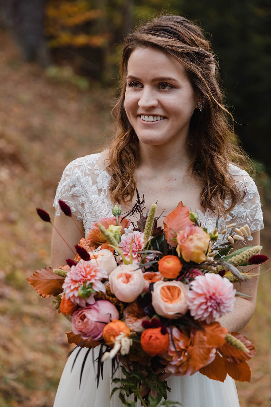  Bride holds bouquet during elopement in the White Mountains in New Hampshire. New Hampshire elopement packages. 