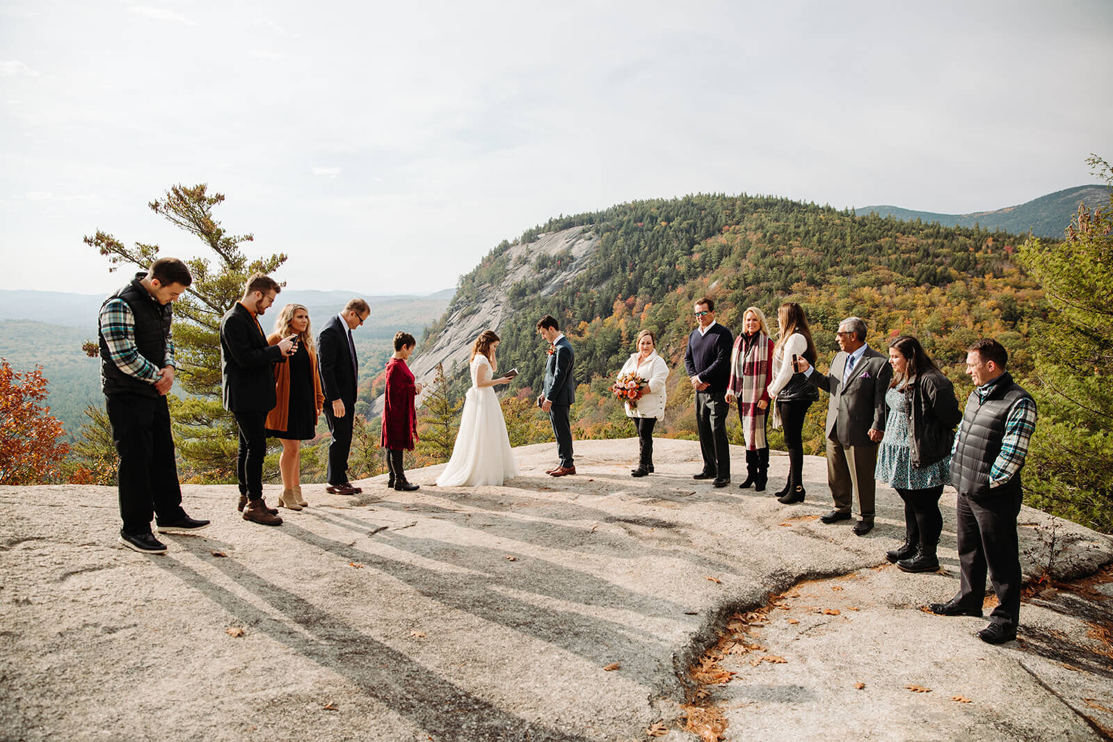  Family joins the bride and groom for their ceremony during elopement in the White Mountains in New Hampshire. New Hampshire elopement packages. 