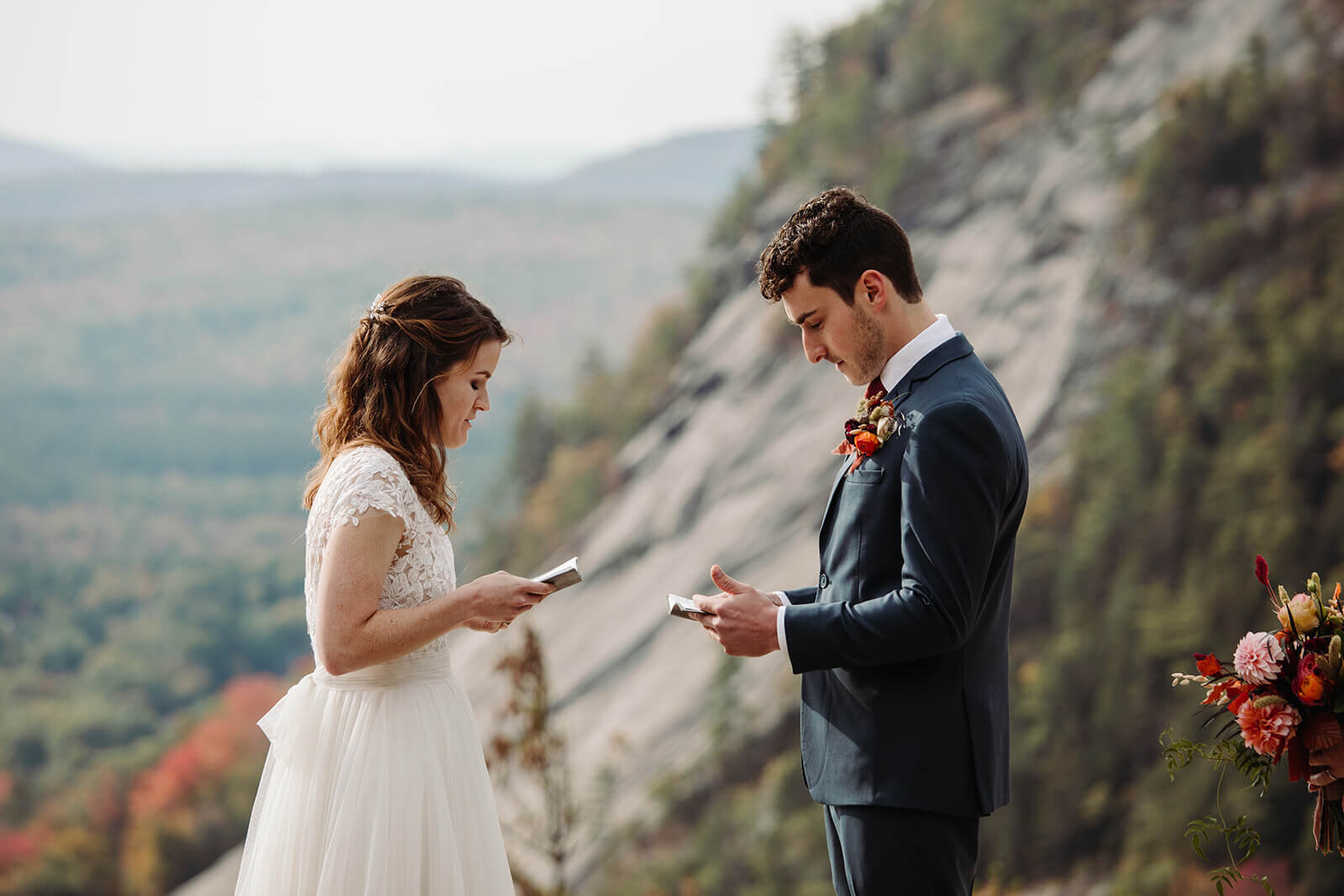  Bride and groom say vows during their ceremony during elopement in the White Mountains in New Hampshire. New Hampshire elopement packages. 