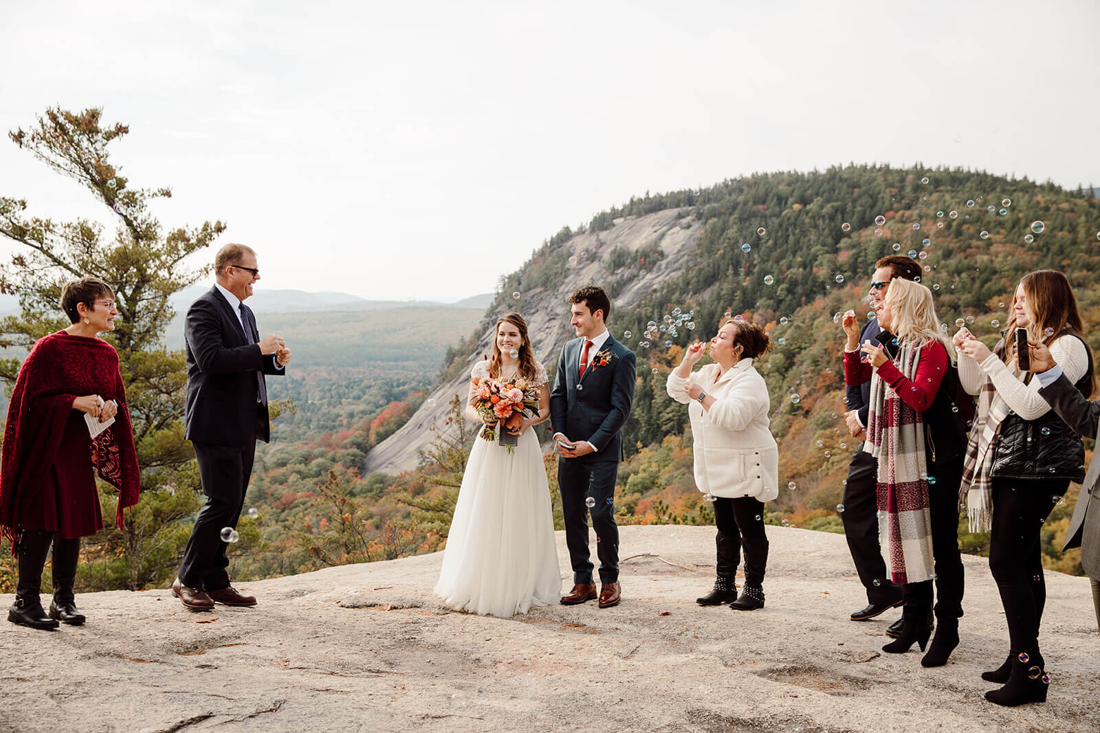  Bride and groom celebrate during their ceremony during elopement in the White Mountains in New Hampshire. New Hampshire elopement packages. 