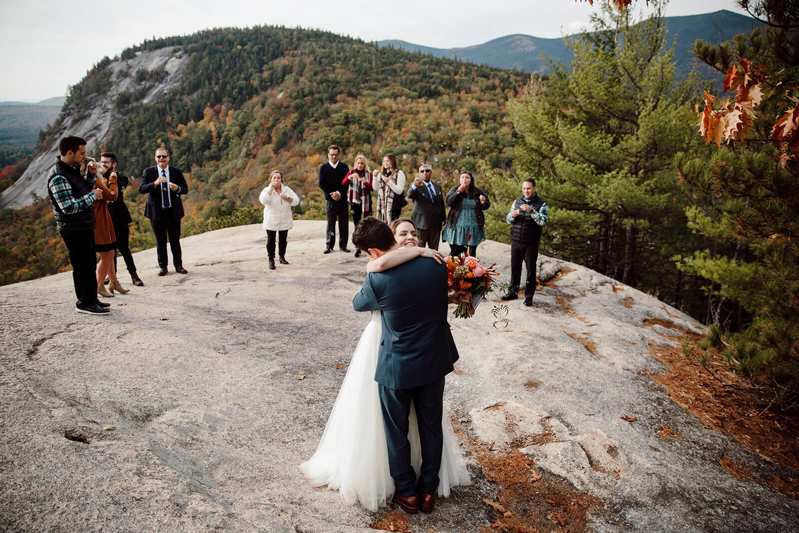  Bride and groom hug during their ceremony during elopement in the White Mountains in New Hampshire. New Hampshire elopement packages. 