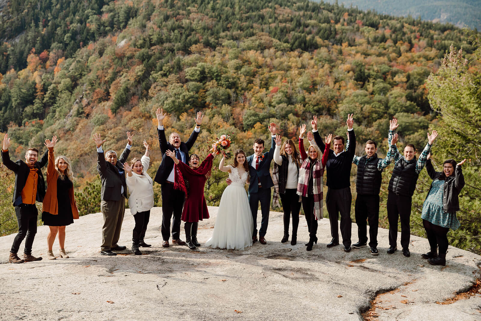  Bride and groom and family celebrate during their ceremony during elopement in the White Mountains in New Hampshire. New Hampshire elopement packages. 