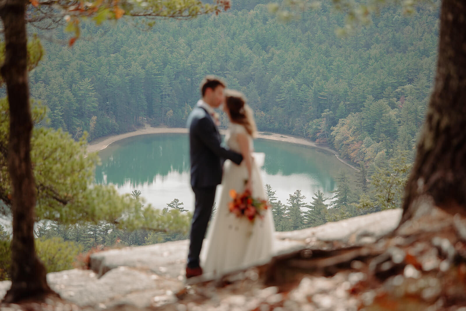  The couple steals a quiet moment after their elopement ceremony to take in the view and each other in the White Mountains in New Hampshire on Cathedral Ledge overlooking Echo Lake. New Hampshire elopement 