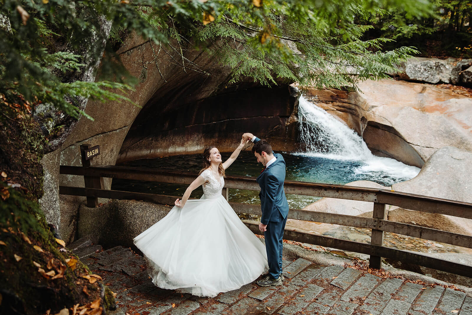  Couple explores the Basin in the forest in Franconia Notch State Park in New Hampshire after their elopement ceremony. New Hampshire elopement packages. 