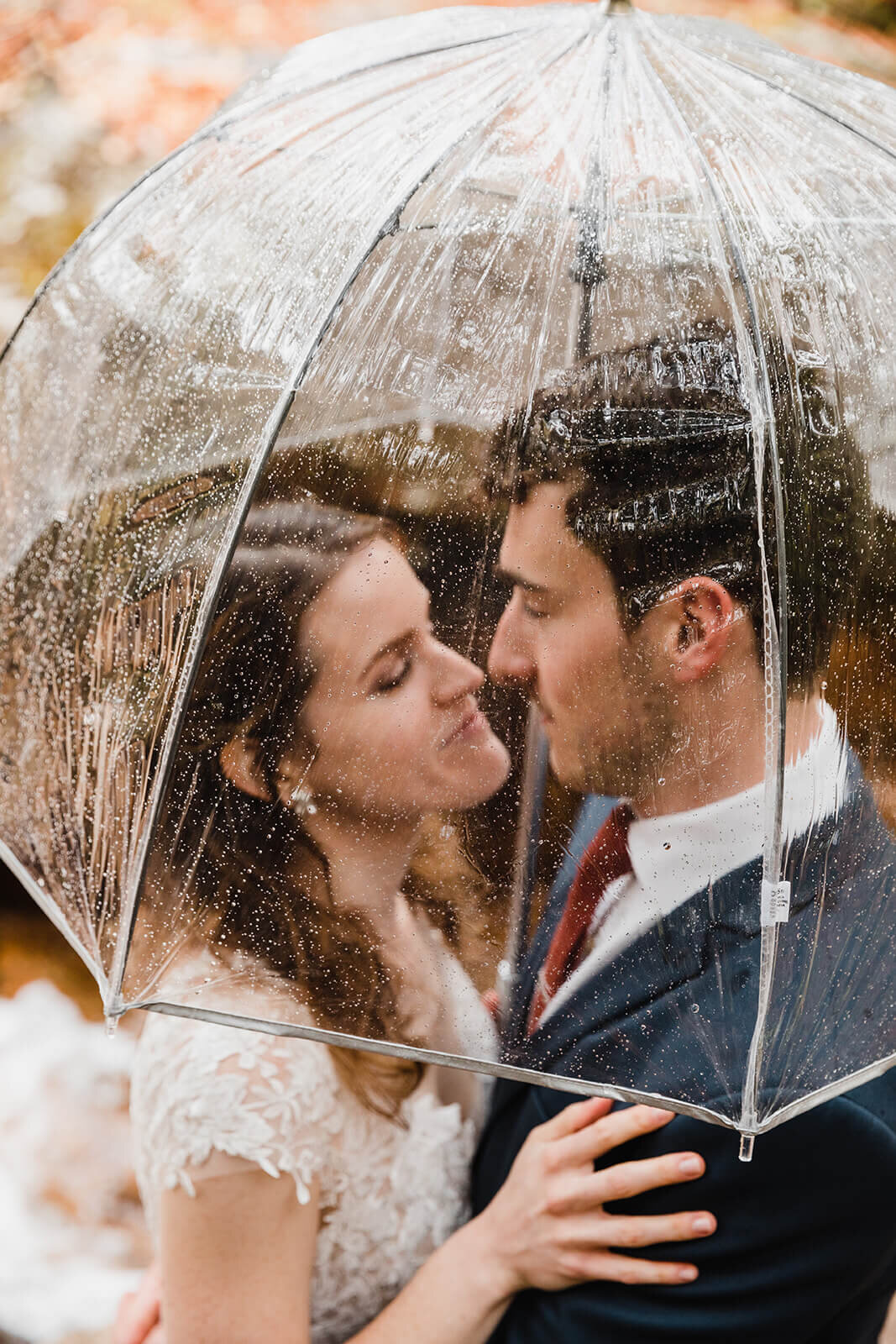  Couple explores the forest in the rain in Franconia Notch State Park in New Hampshire after their elopement ceremony. New Hampshire elopement packages. 