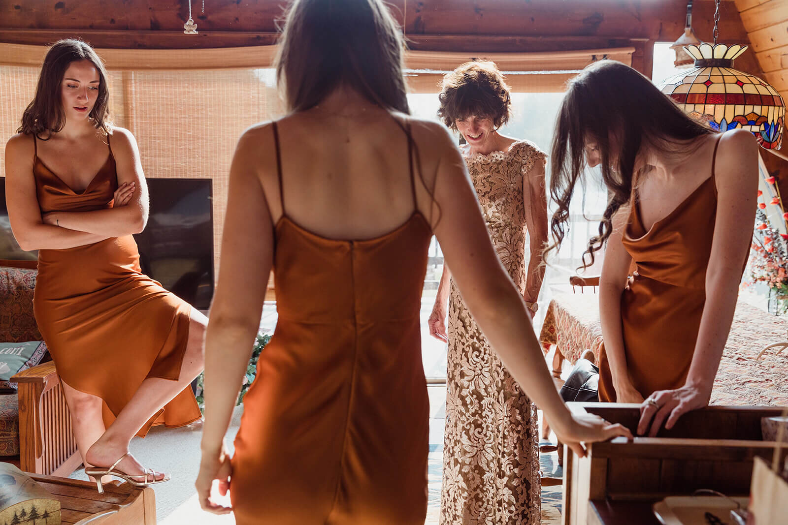  Bride gets ready with the help of her sisters and mom during her gorgeous small wedding in the Adirondacks, Upstate NY during the fall. Adirondack wedding packages. Upstate NY elopement packages. 