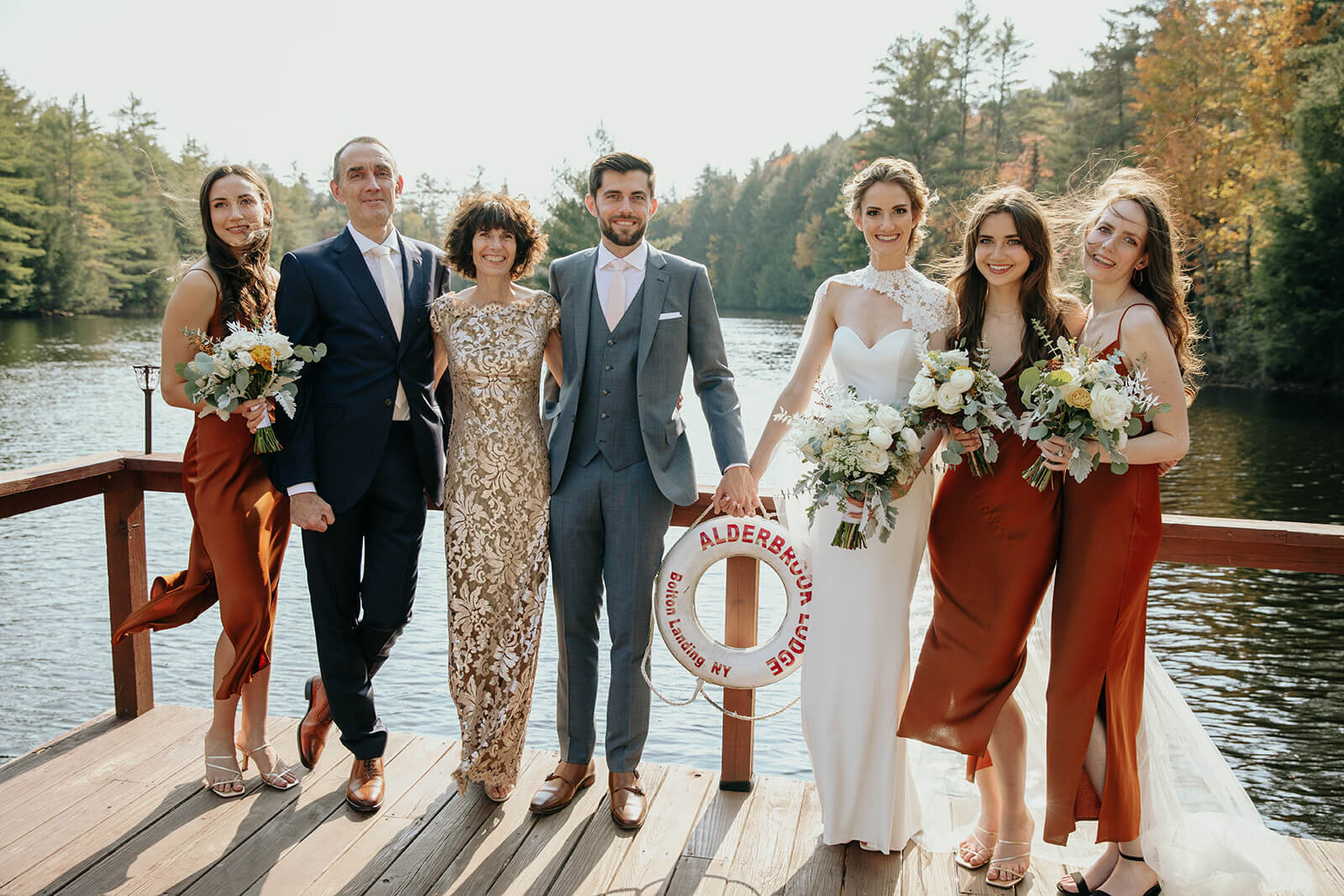  Formal family portrait on dock at beautiful lake lodge in the Adirondacks in Upstate New York. 