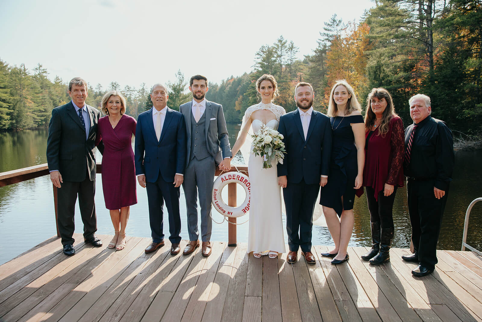  Formal family portrait on dock at beautiful lake lodge in the Adirondacks in Upstate New York. 