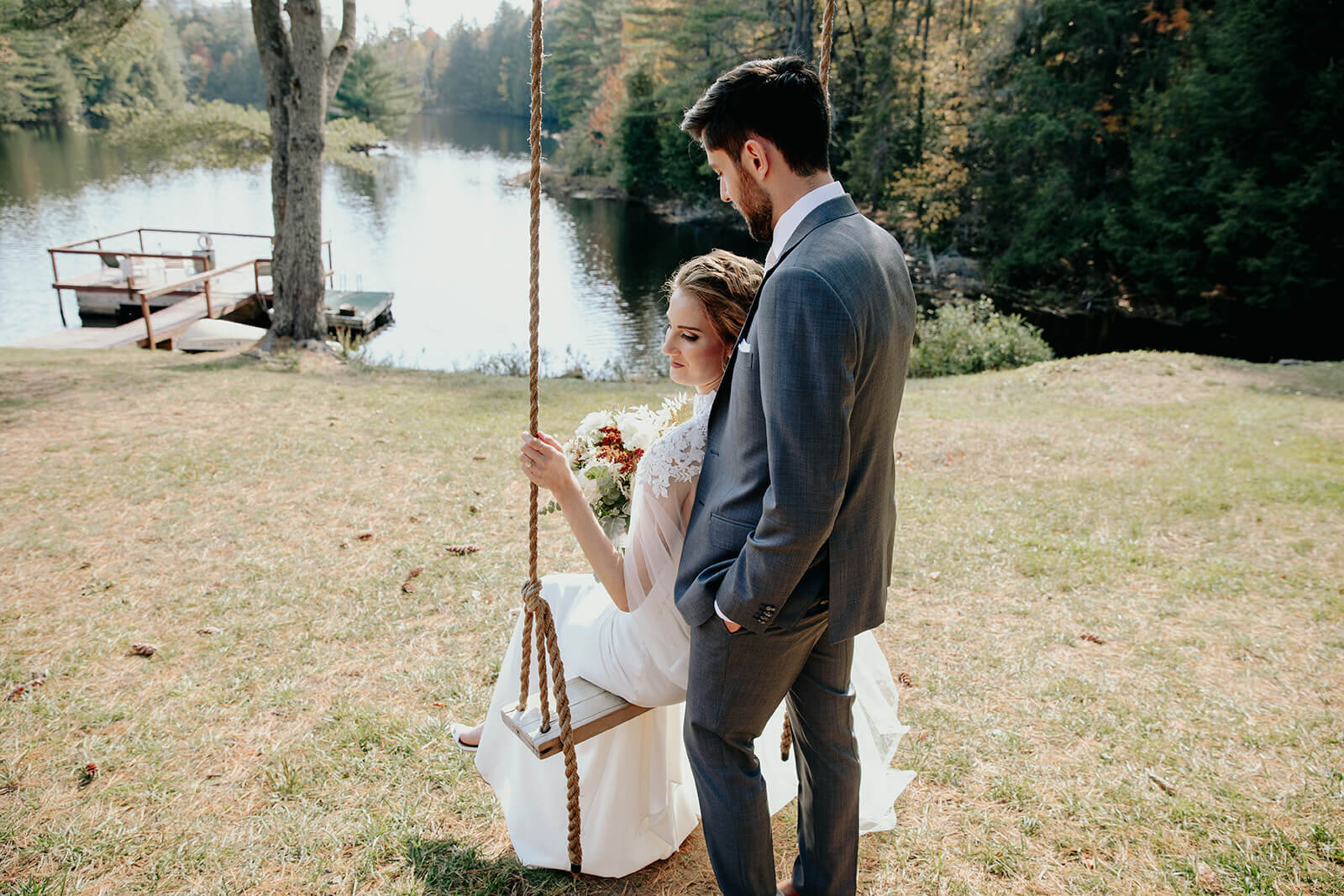  Bride and groom swing during their small wedding at a gorgeous lake in the Adirondacks in Upstate NY. 