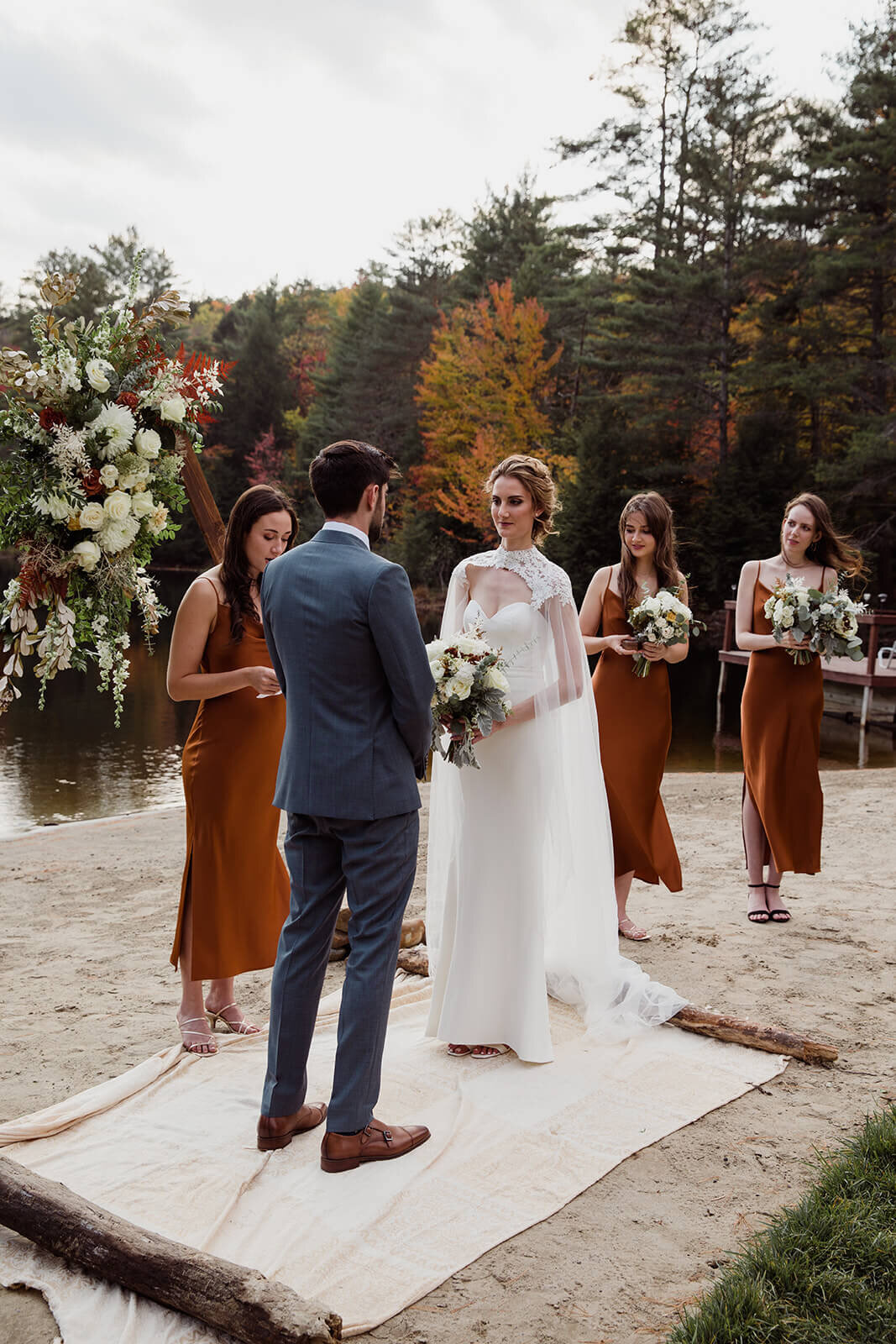  Small outdoor wedding on lake beach during the fall in the Adirondacks in Upstate New York. New York wedding packages. Upstate NY elopement packages. 