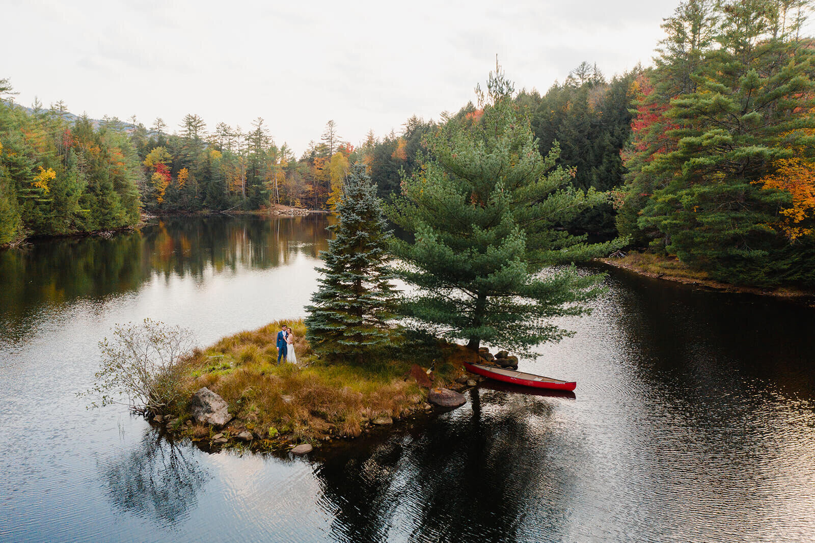  Bride and groom set out in a canoe to paddle to the island in the middle of this awesome private lake in Upstate NY in the Adirondacks. Canoeing elopement upstate NY. 