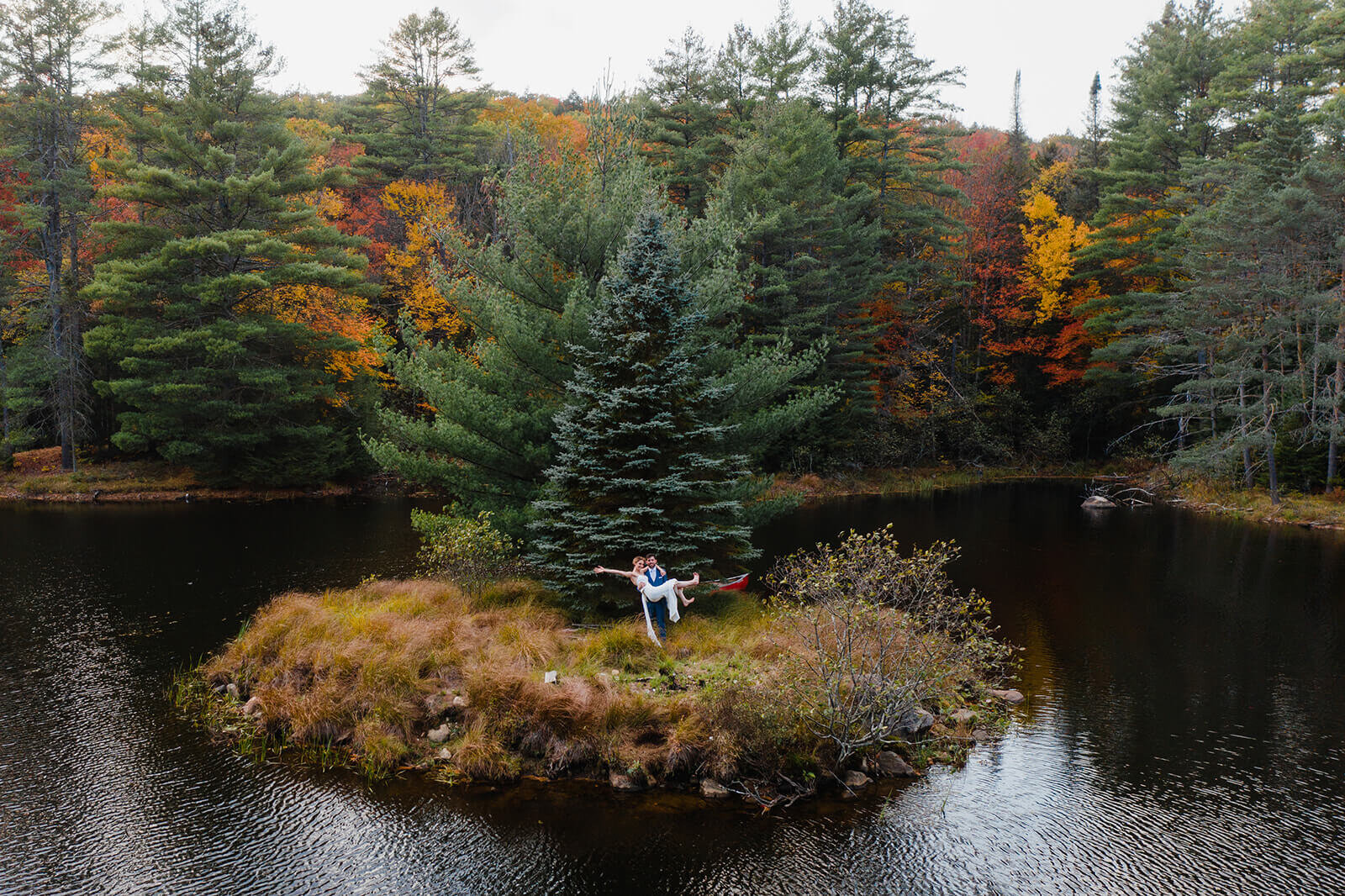  Bride and groom set out in a canoe to paddle to the island in the middle of this awesome private lake in Upstate NY in the Adirondacks. Canoeing elopement upstate NY. 