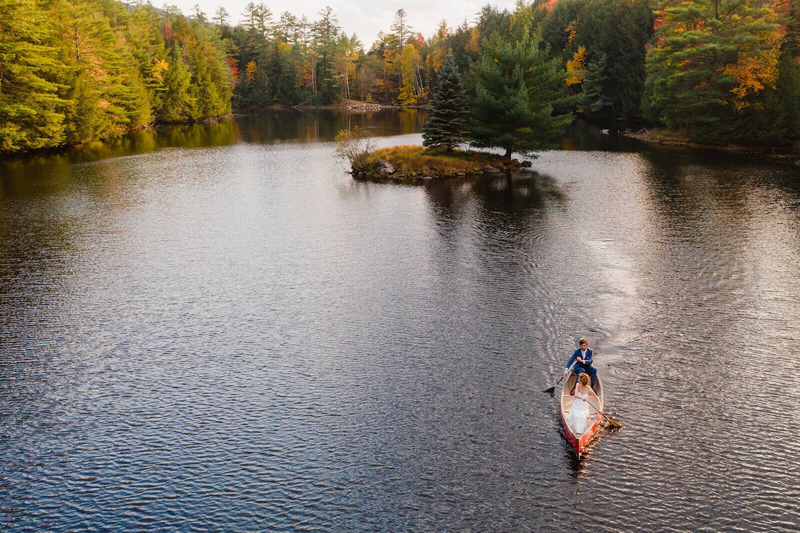  Bride and groom set out in a canoe to paddle to the island in the middle of this awesome private lake in Upstate NY in the Adirondacks. Canoeing elopement upstate NY. 