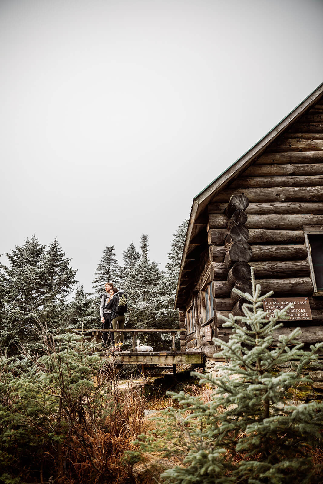 Eloping couple stops at a lodge that is part of the Long Trail during their adventure elopement on Mt. Mansfield, Vermont’s tallest mountain.  Vermont mountain wedding. Vermont winter elopement. Vermont elopement packages. 