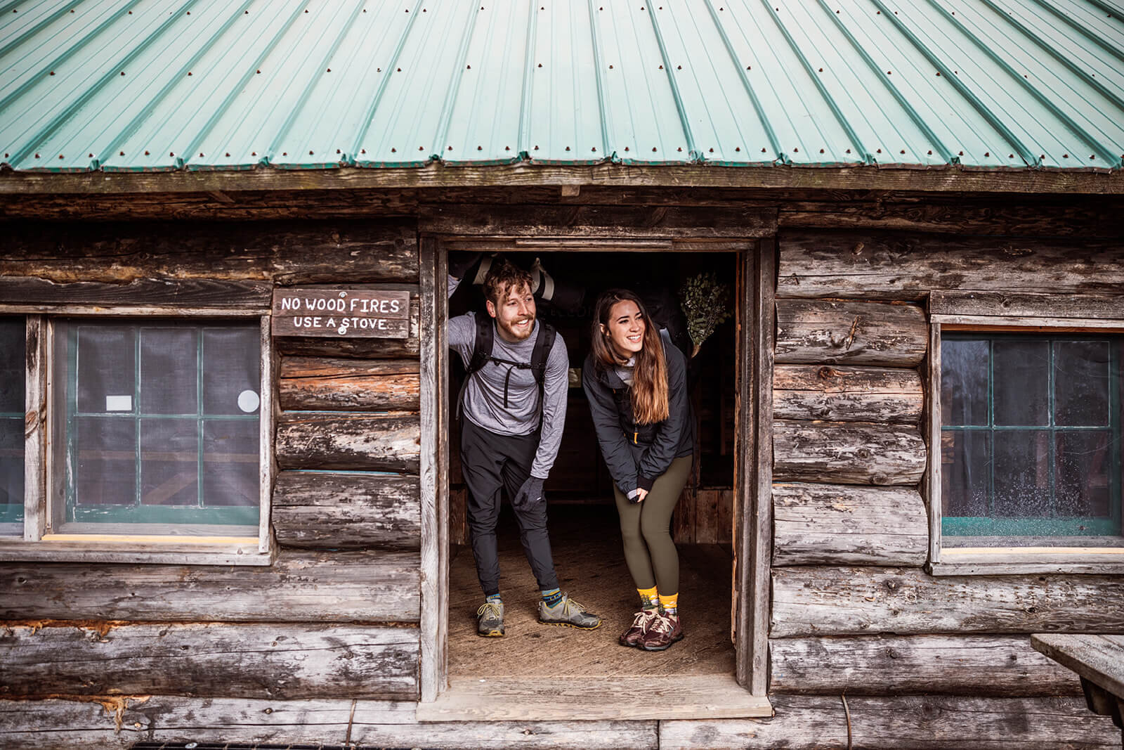  Eloping couple stops at a lodge that is part of the Long Trail during their adventure elopement on Mt. Mansfield, Vermont’s tallest mountain.  Vermont mountain wedding. Vermont winter elopement. Vermont elopement packages. 