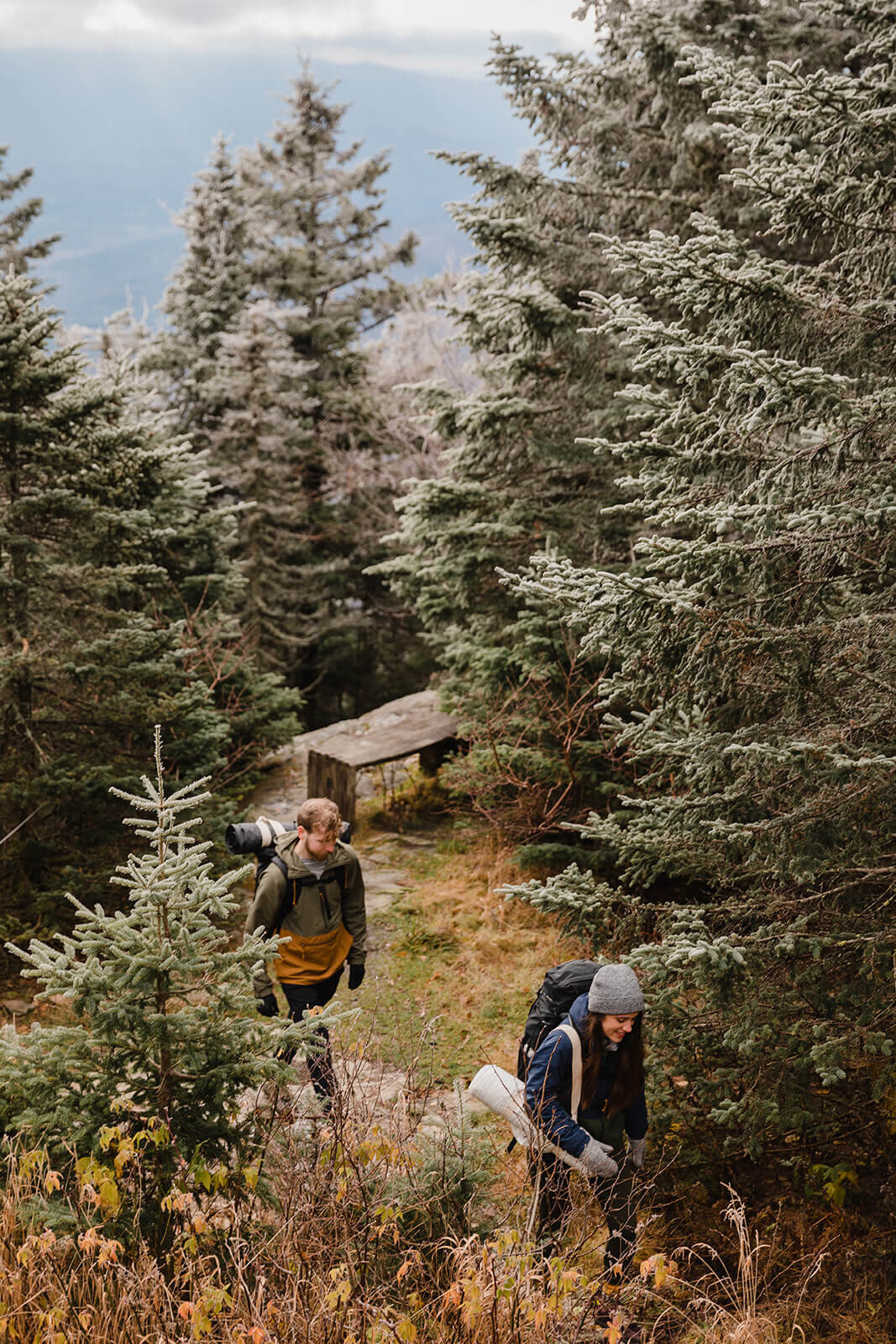  Eloping couple explores the trail during their adventure elopement on Mt. Mansfield, Vermont’s tallest mountain.  Vermont mountain wedding. Vermont winter elopement. Vermont elopement packages. 