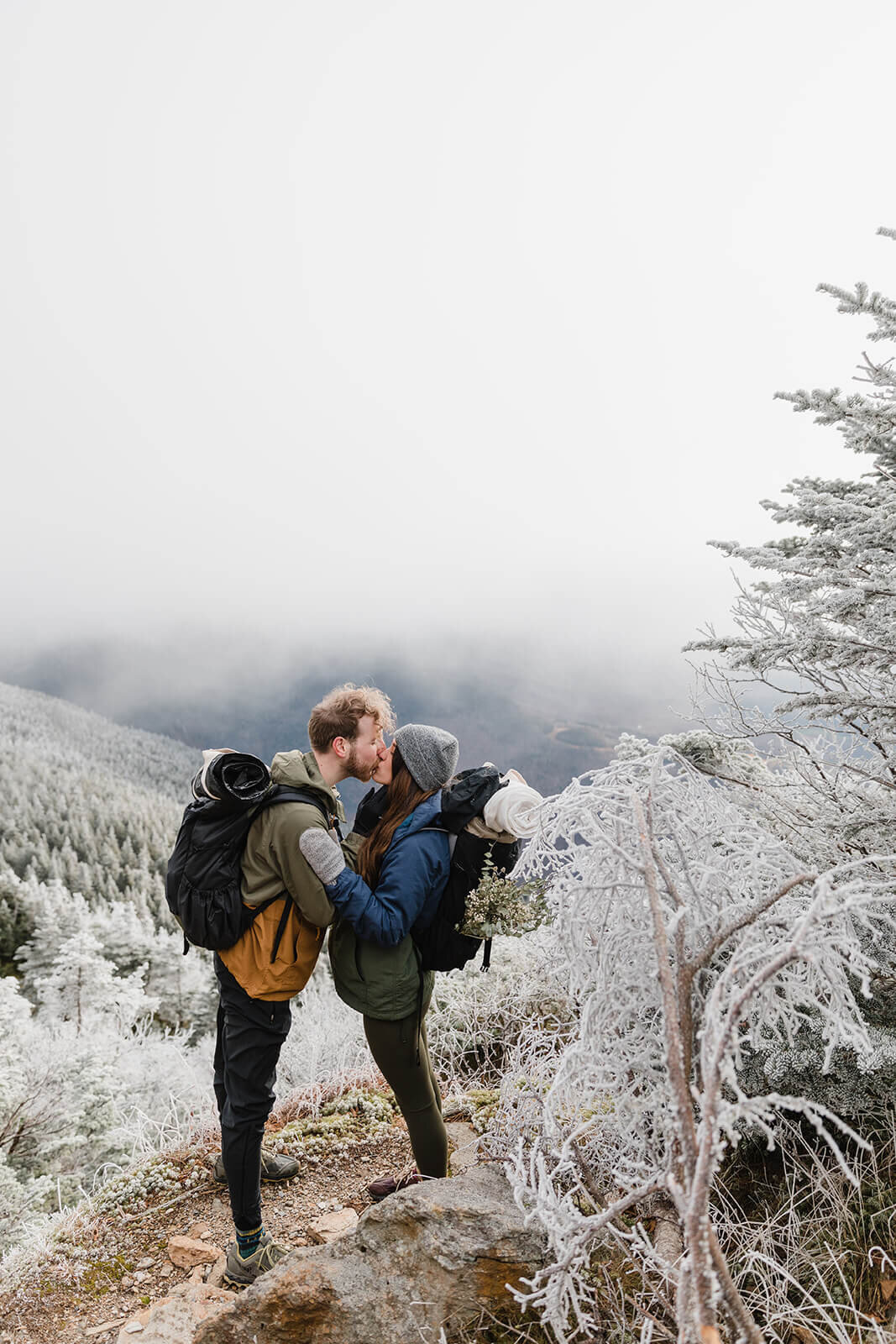  Eloping couple explores the trail during their adventure elopement on Mt. Mansfield, Vermont’s tallest mountain.  Vermont mountain wedding. Vermont winter elopement. Vermont elopement packages. 