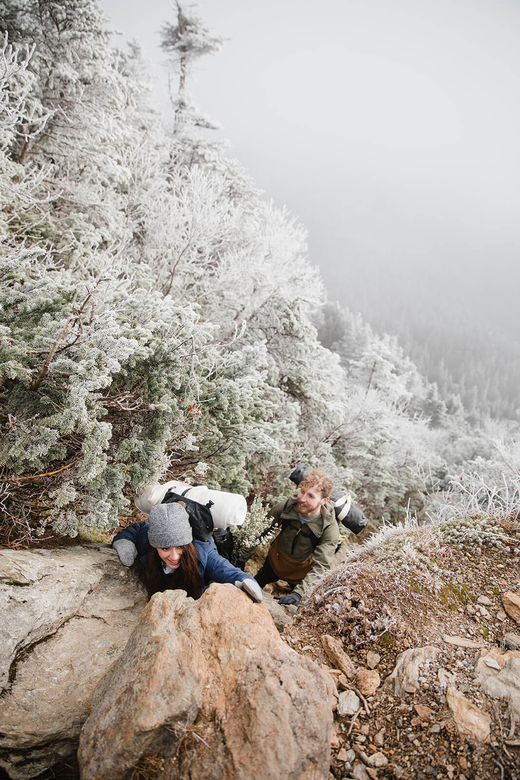  Eloping couple explores the trail during their adventure elopement on Mt. Mansfield, Vermont’s tallest mountain.  Vermont mountain wedding. Vermont winter elopement. Vermont elopement packages. 