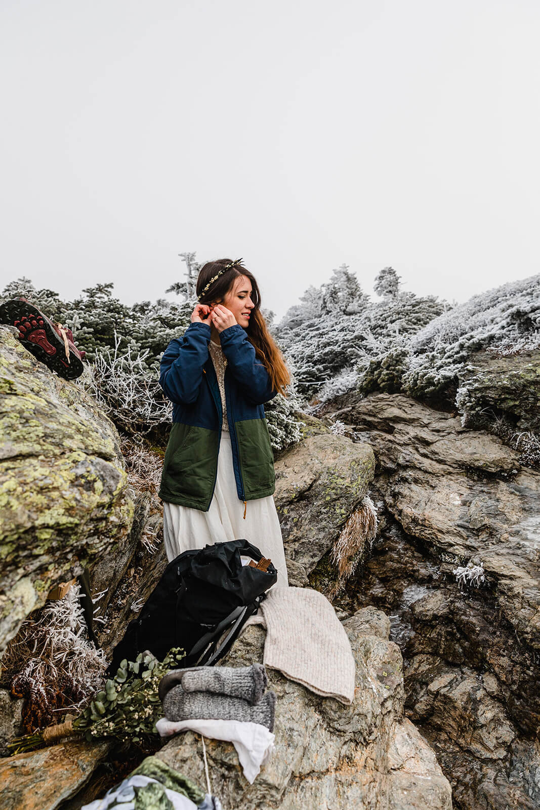  Eloping couple gets ready in frosty conditions during their adventure elopement on Mt. Mansfield, Vermont’s tallest mountain.  Vermont mountain wedding. Vermont winter elopement. Vermont elopement packages. 
