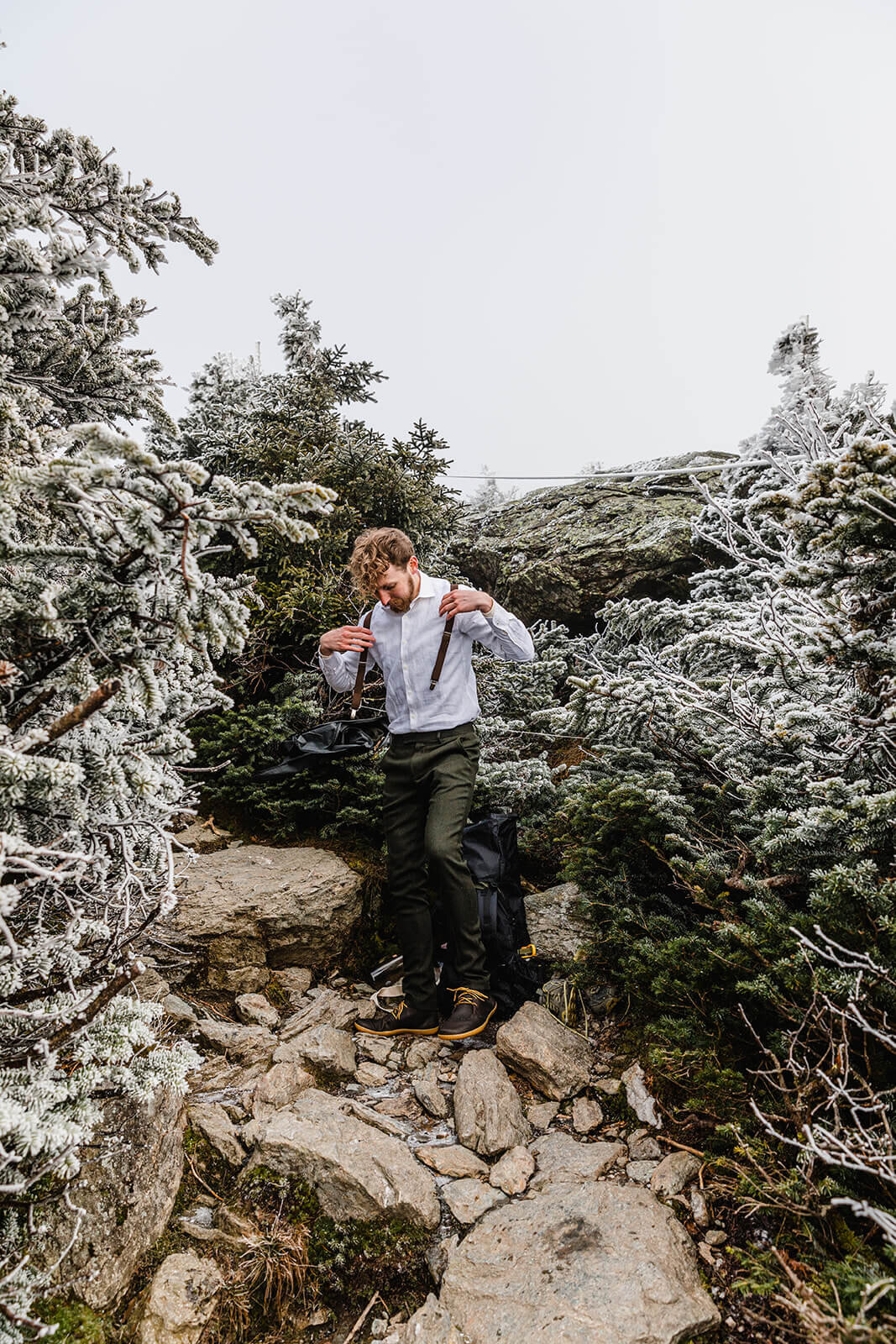  Eloping couple gets ready in frosty conditions during their adventure elopement on Mt. Mansfield, Vermont’s tallest mountain.  Vermont mountain wedding. Vermont winter elopement. Vermont elopement packages. 