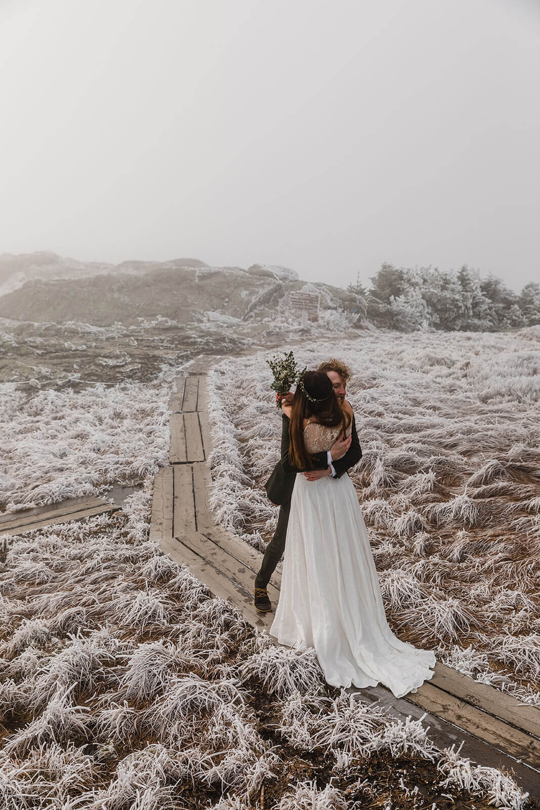  Eloping couple enjoys first look in frosty conditions during their adventure elopement on Mt. Mansfield, Vermont’s tallest mountain.  Vermont mountain wedding. Vermont winter elopement. Vermont elopement packages. 