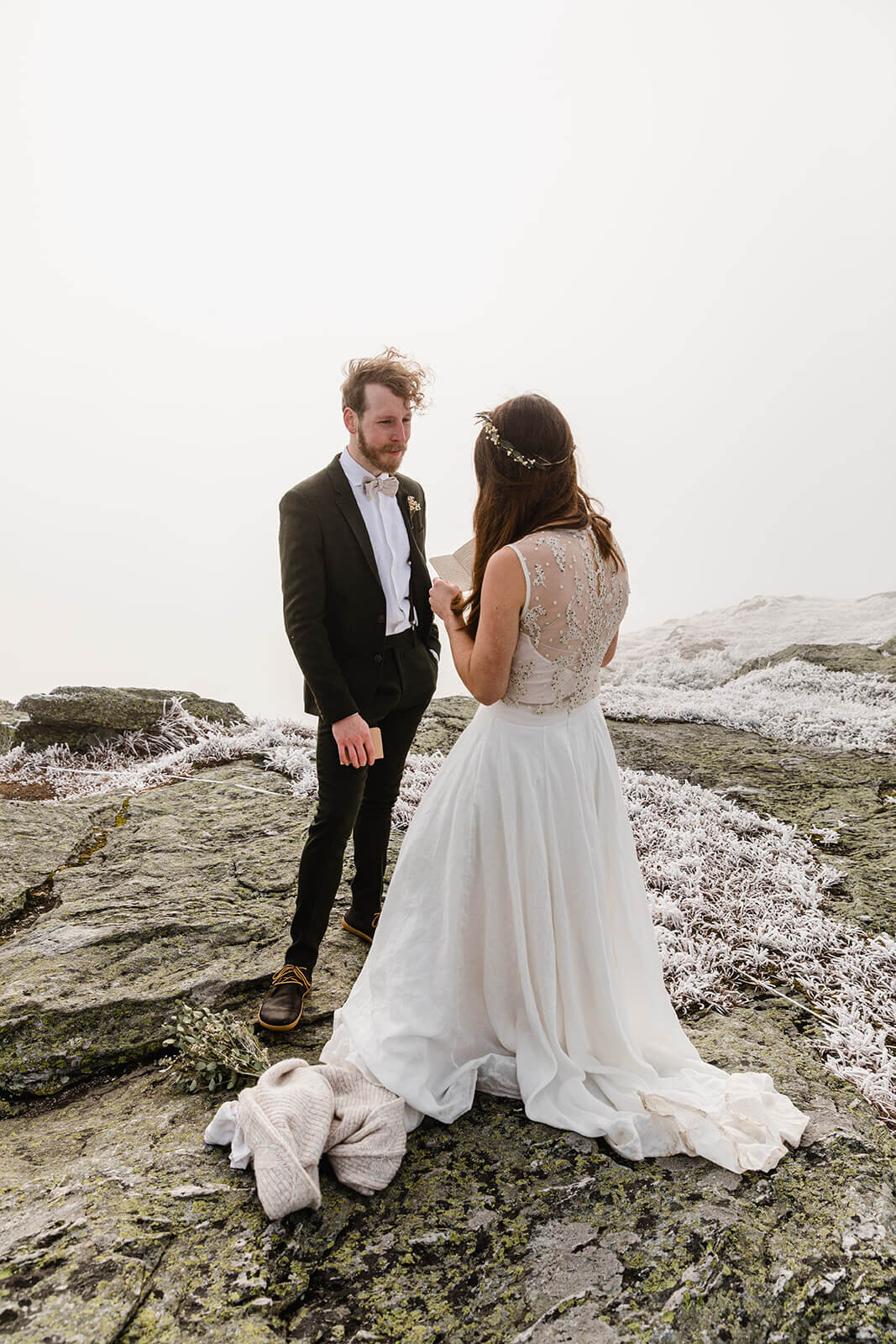  Eloping couple has ceremony in frosty conditions during their adventure elopement on Mt. Mansfield, Vermont’s tallest mountain.  Vermont mountain wedding. Vermont winter elopement. Vermont elopement packages. 