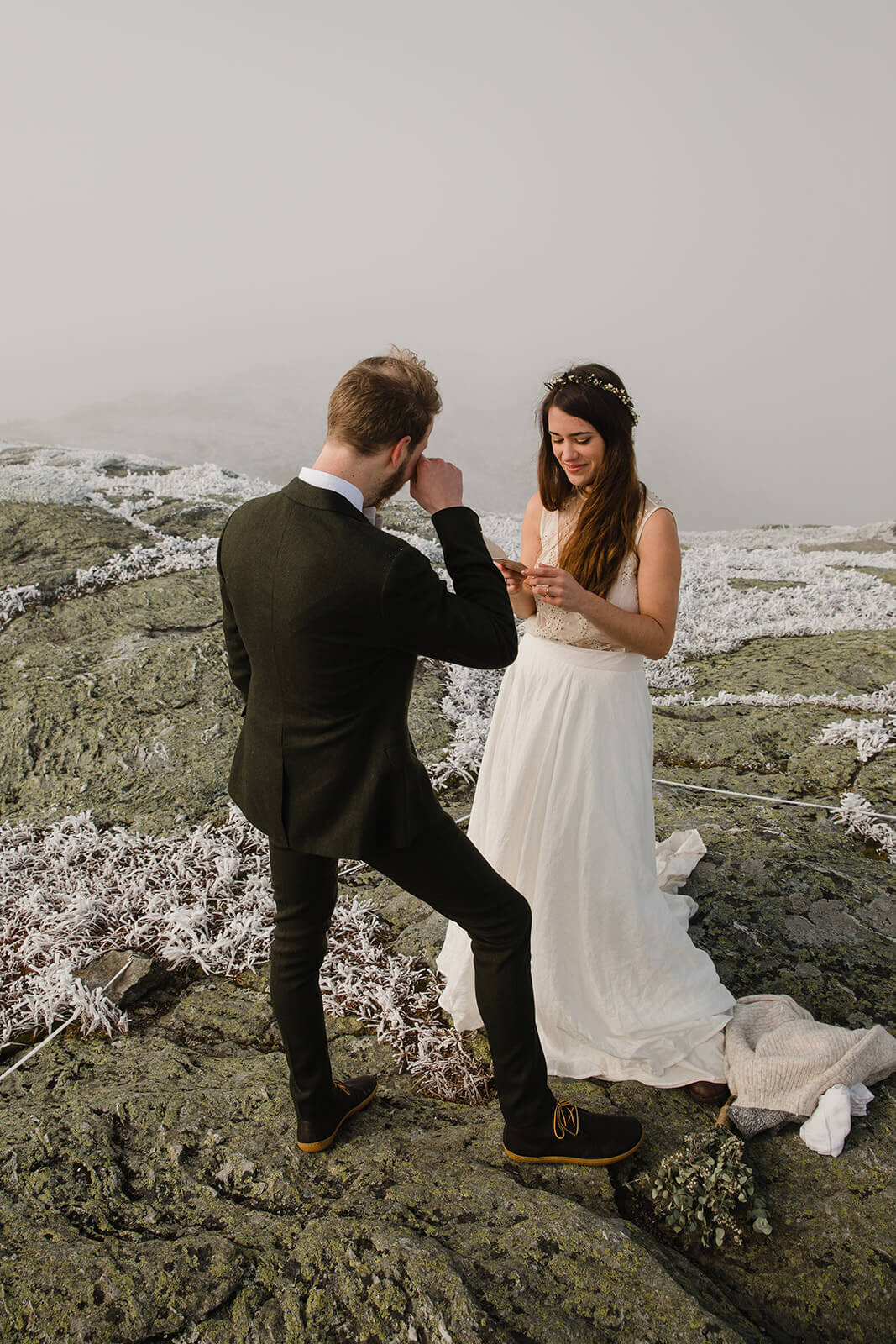  Eloping couple exchanges vows in frosty conditions during their adventure elopement on Mt. Mansfield, Vermont’s tallest mountain.  Vermont mountain wedding. Vermont winter elopement. Vermont elopement packages. 