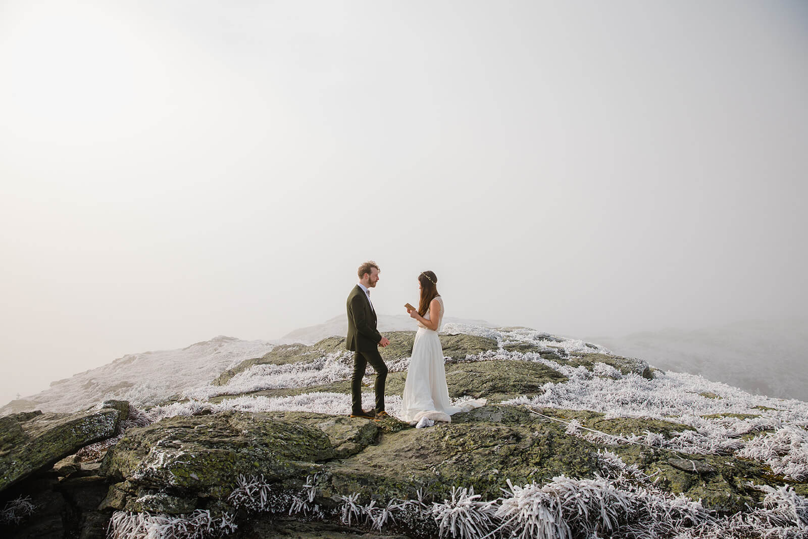  Eloping couple exchanges vows in frosty conditions during their adventure elopement on Mt. Mansfield, Vermont’s tallest mountain.  Vermont mountain wedding. Vermont winter elopement. Vermont elopement packages. 