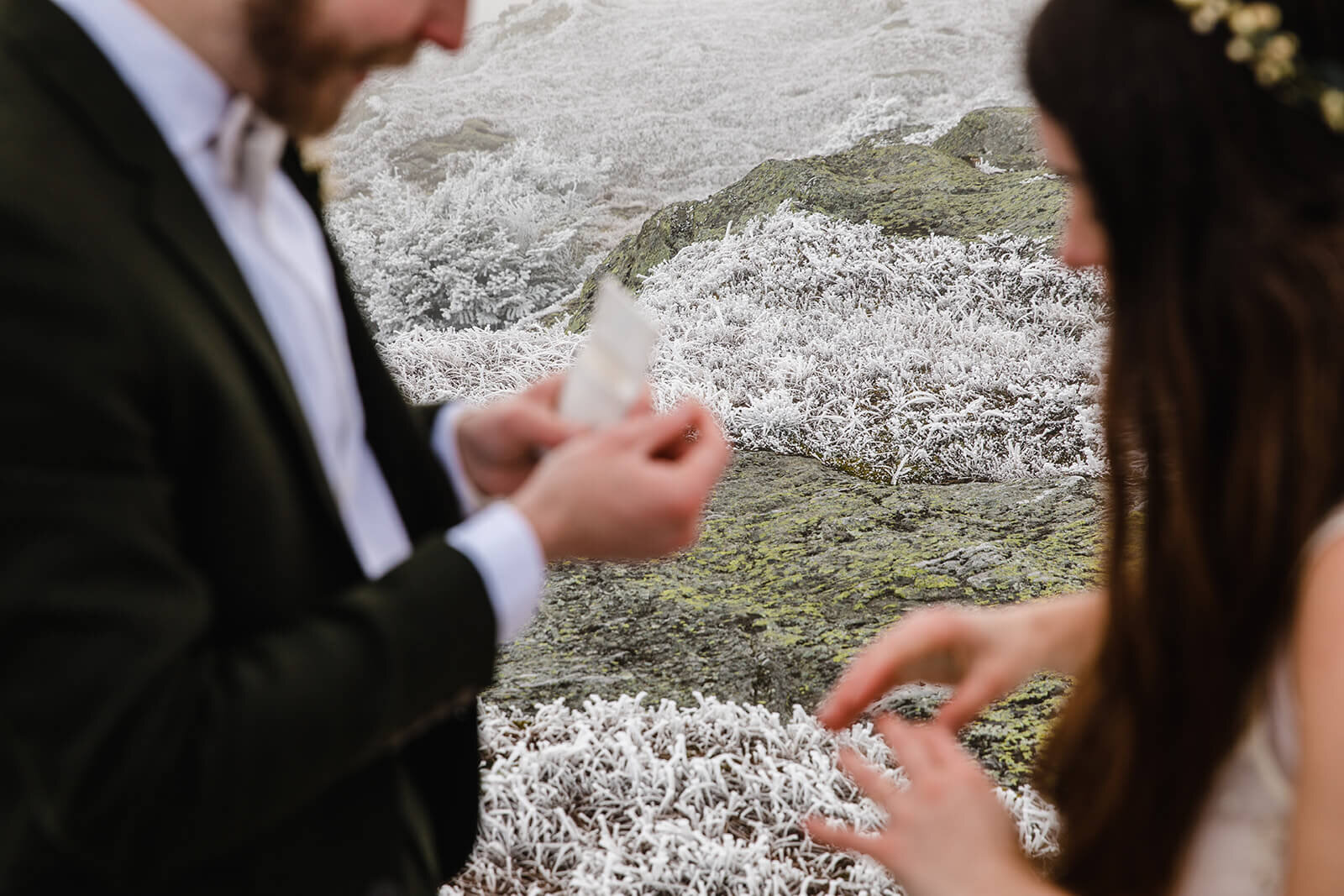  Eloping couple exchanges vows in frosty conditions during their adventure elopement on Mt. Mansfield, Vermont’s tallest mountain.  Vermont mountain wedding. Vermont winter elopement. Vermont elopement packages. 