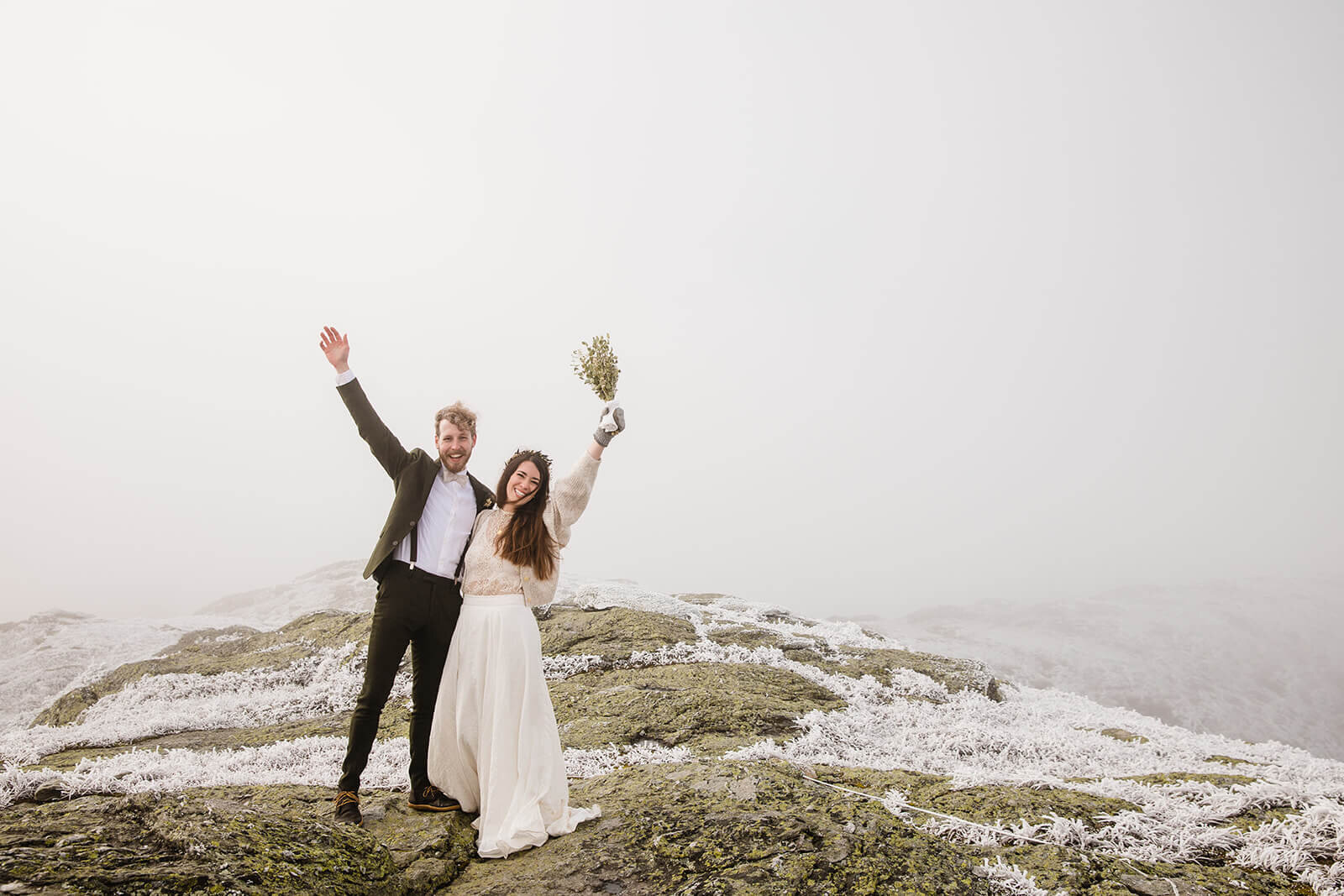  Eloping couple celebrates in frosty conditions during their adventure elopement on Mt. Mansfield, Vermont’s tallest mountain.  Vermont mountain wedding. Vermont winter elopement. Vermont elopement packages. 
