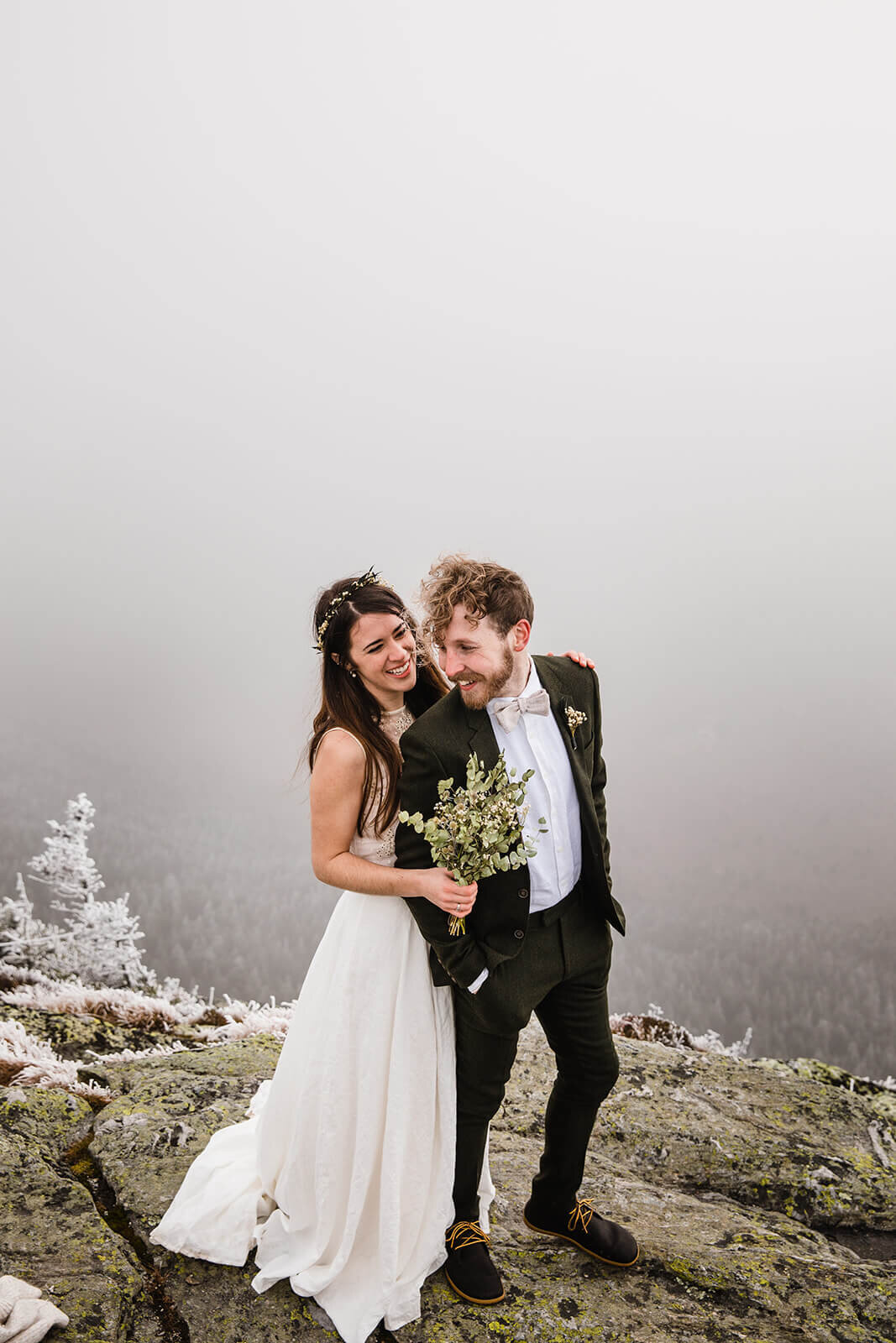  Eloping couple explores summit during their adventure elopement on Mt. Mansfield, Vermont’s tallest mountain.  Vermont mountain wedding. Vermont winter elopement. Vermont elopement packages. 