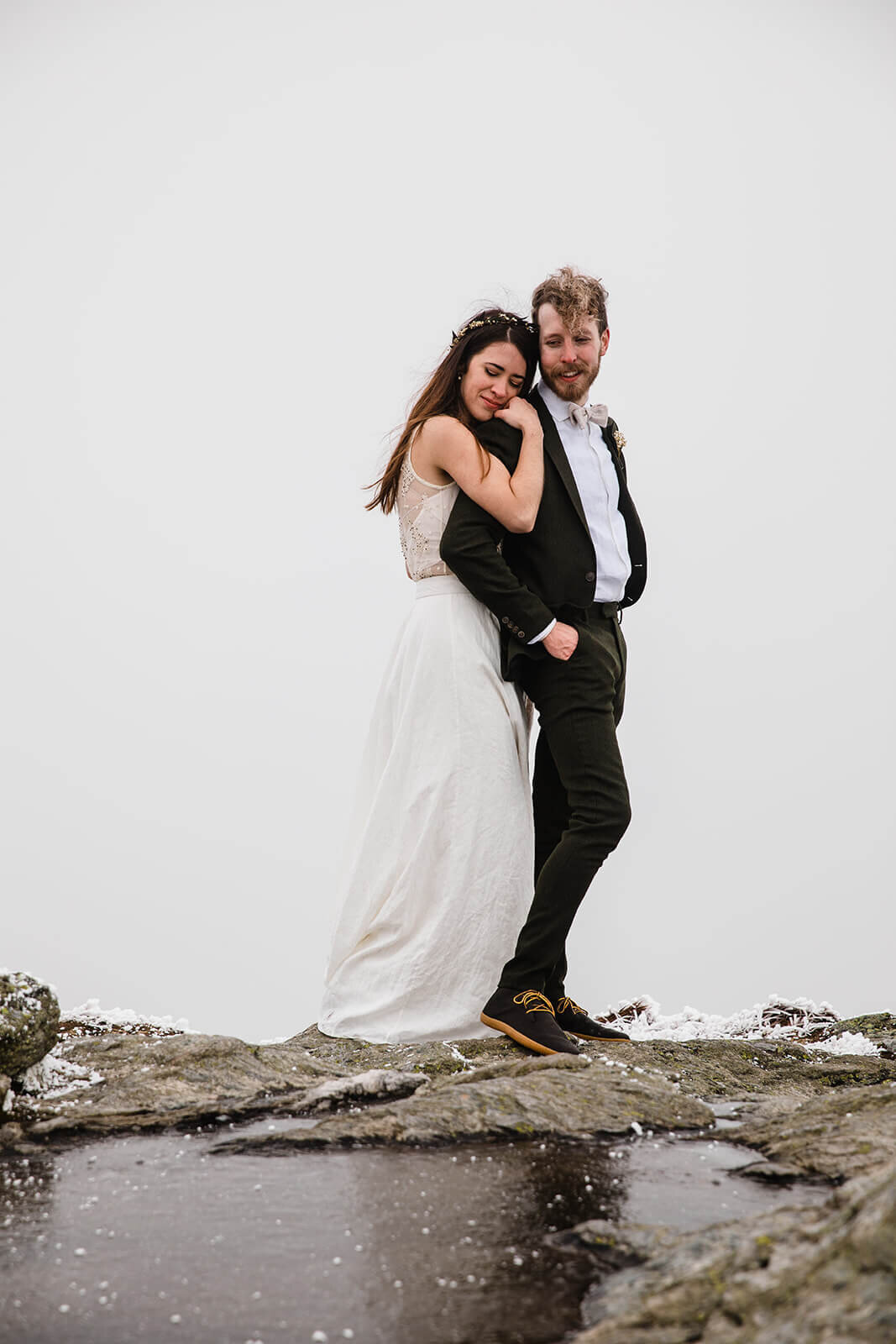  Eloping couple explores summit during their adventure elopement on Mt. Mansfield, Vermont’s tallest mountain.  Vermont mountain wedding. Vermont winter elopement. Vermont elopement packages. 