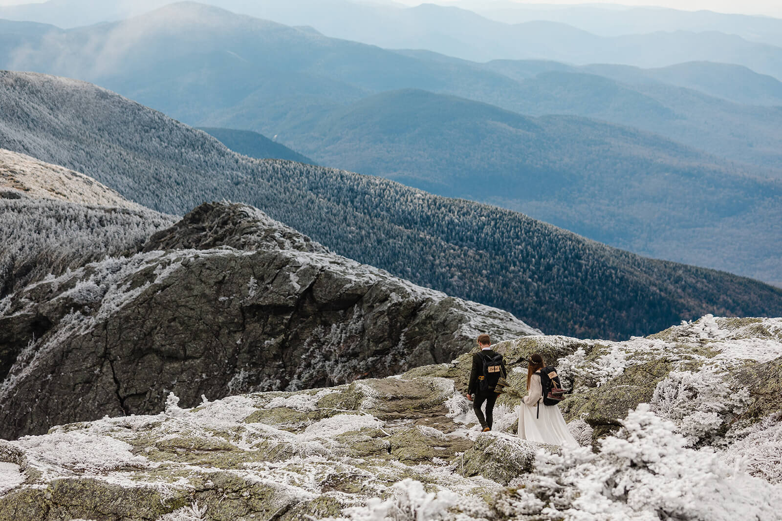  Eloping couple explores summit during their adventure elopement on Mt. Mansfield, Vermont’s tallest mountain.  Vermont mountain wedding. Vermont winter elopement. Vermont elopement packages. 