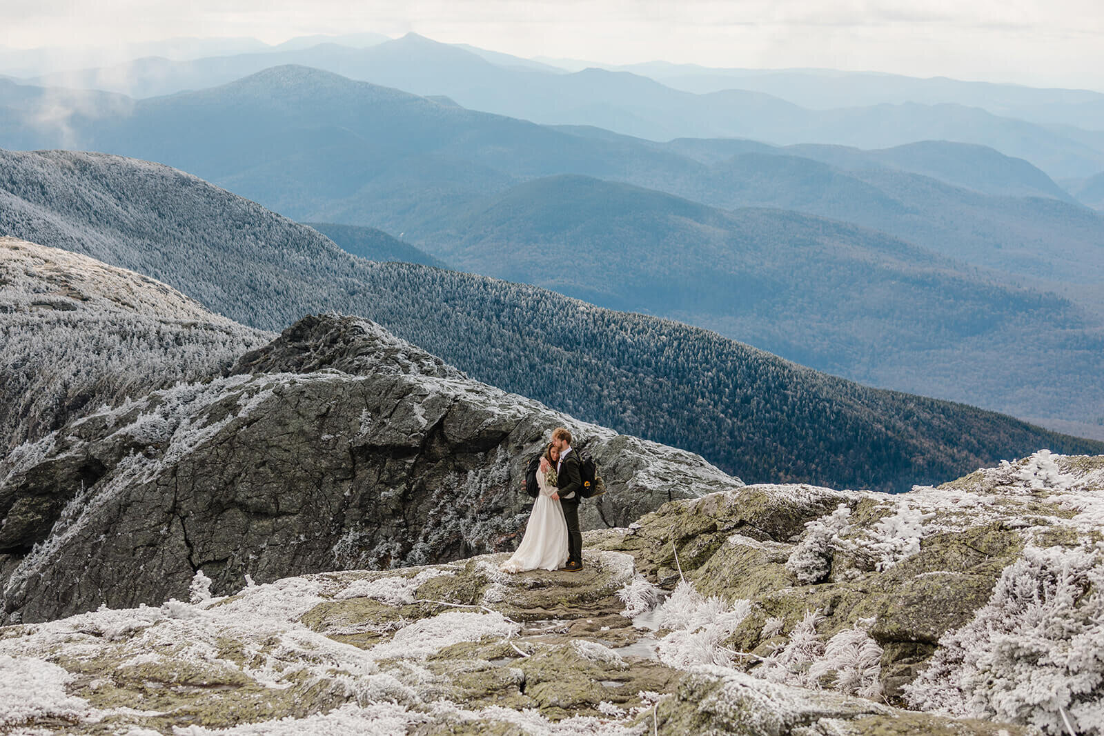  Eloping couple explores summit during their adventure elopement on Mt. Mansfield, Vermont’s tallest mountain.  Vermont mountain wedding. Vermont winter elopement. Vermont elopement packages. 