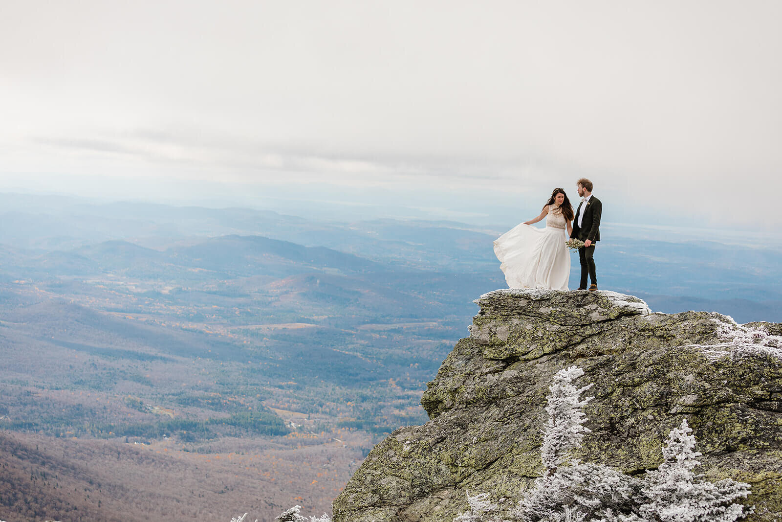  Eloping couple explores summit during their adventure elopement on Mt. Mansfield, Vermont’s tallest mountain.  Vermont mountain wedding. Vermont winter elopement. Vermont elopement packages. 