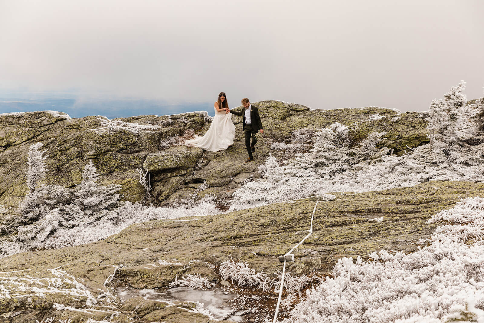  Eloping couple explores summit during their adventure elopement on Mt. Mansfield, Vermont’s tallest mountain.  Vermont mountain wedding. Vermont winter elopement. Vermont elopement packages. 
