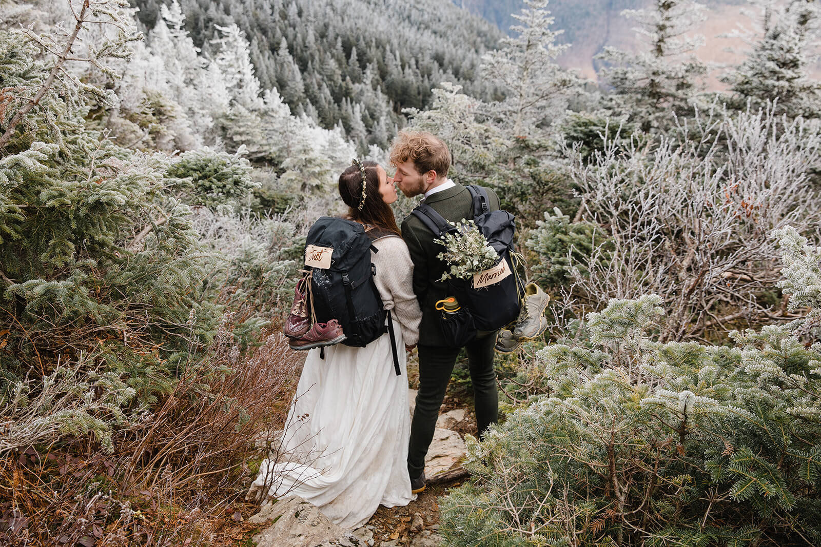  Eloping couple explores summit during their adventure elopement on Mt. Mansfield, Vermont’s tallest mountain.  Vermont mountain wedding. Vermont winter elopement. Vermont elopement packages. 