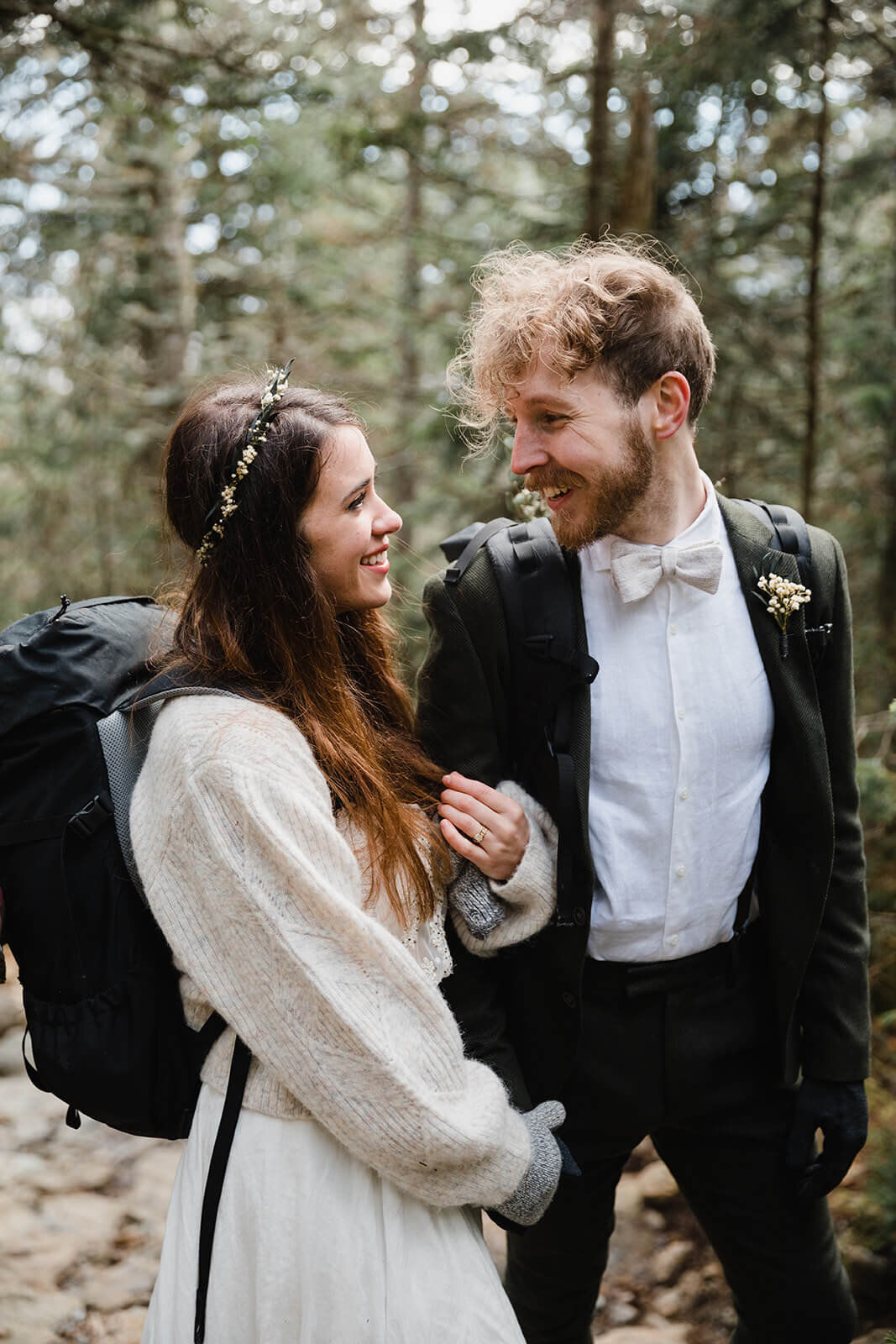  Eloping couple explores trail during their adventure elopement on Mt. Mansfield, Vermont’s tallest mountain.  Vermont mountain wedding. Vermont winter elopement. Vermont elopement packages. 