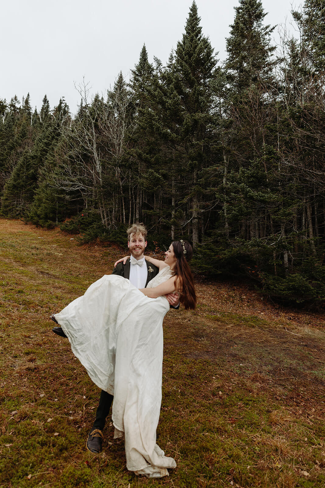  Eloping couple explores trail during their adventure elopement on Mt. Mansfield, Vermont’s tallest mountain.  Vermont mountain wedding. Vermont winter elopement. Vermont elopement packages. 