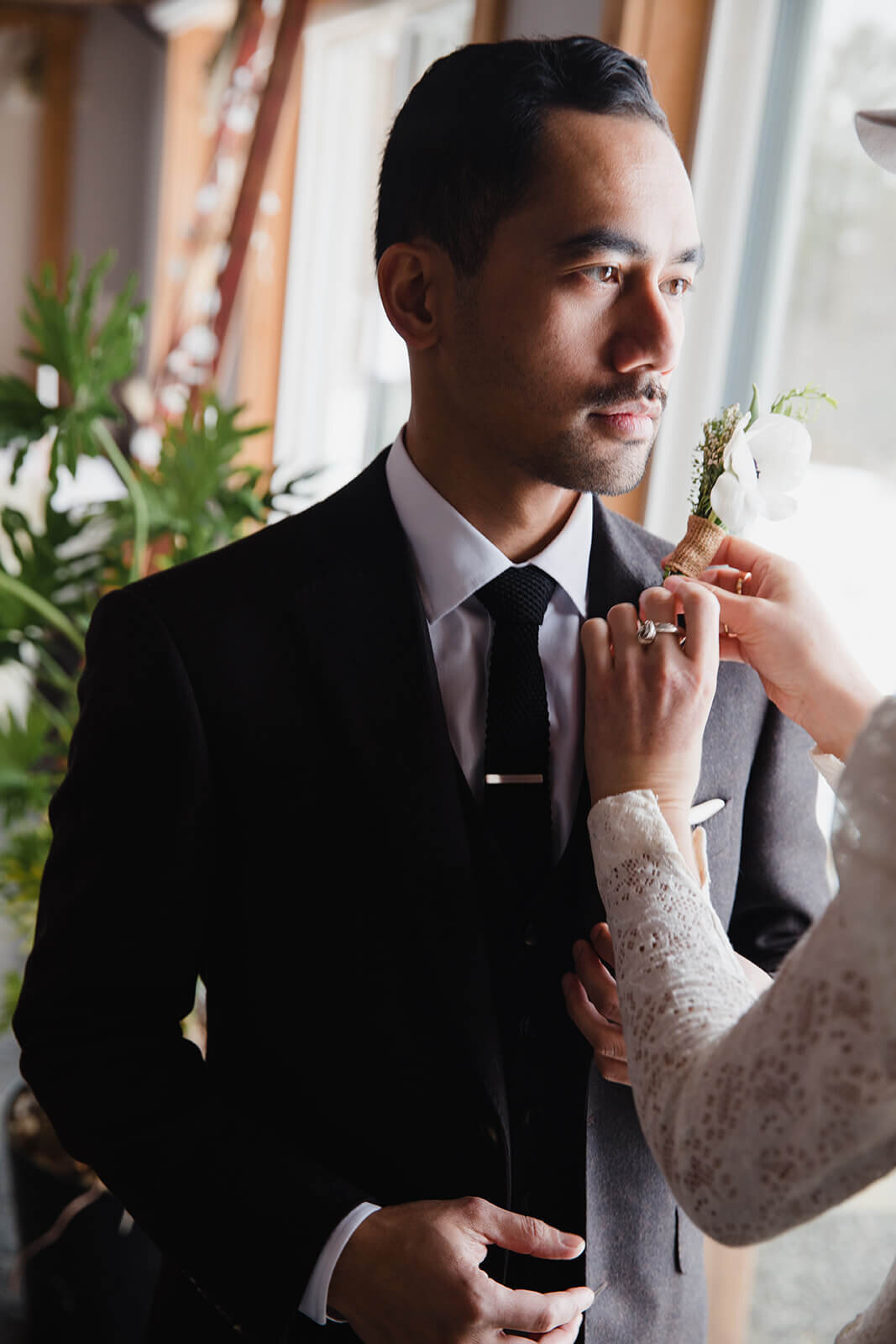  Stylish NYC couple elope late winter in the Finger Lakes region of Upstate NY. They put on boutonniere.  