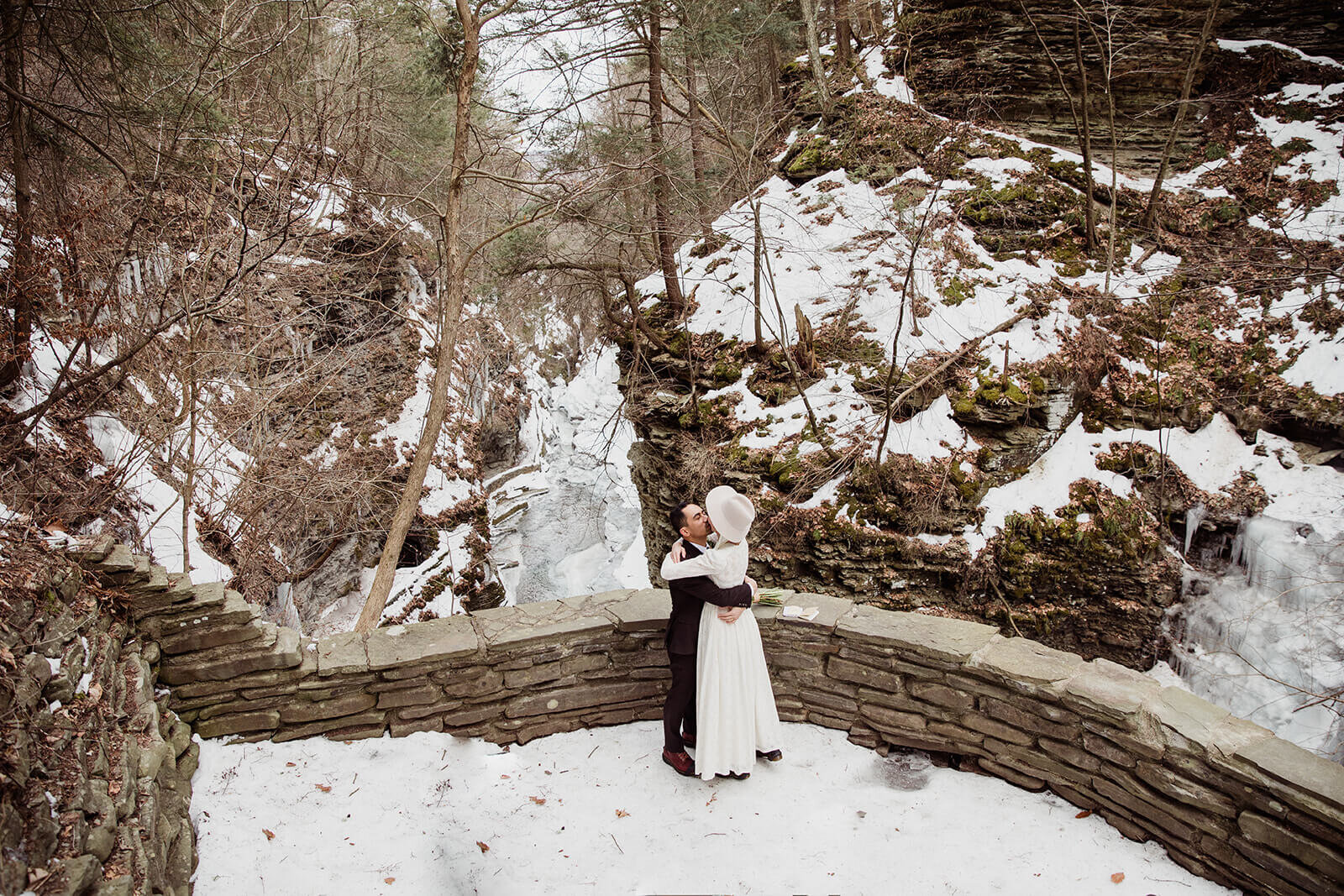  Stylish NYC couple elope late winter in the Finger Lakes region of Upstate NY. Couple exchanges vows and rings during ceremony. 